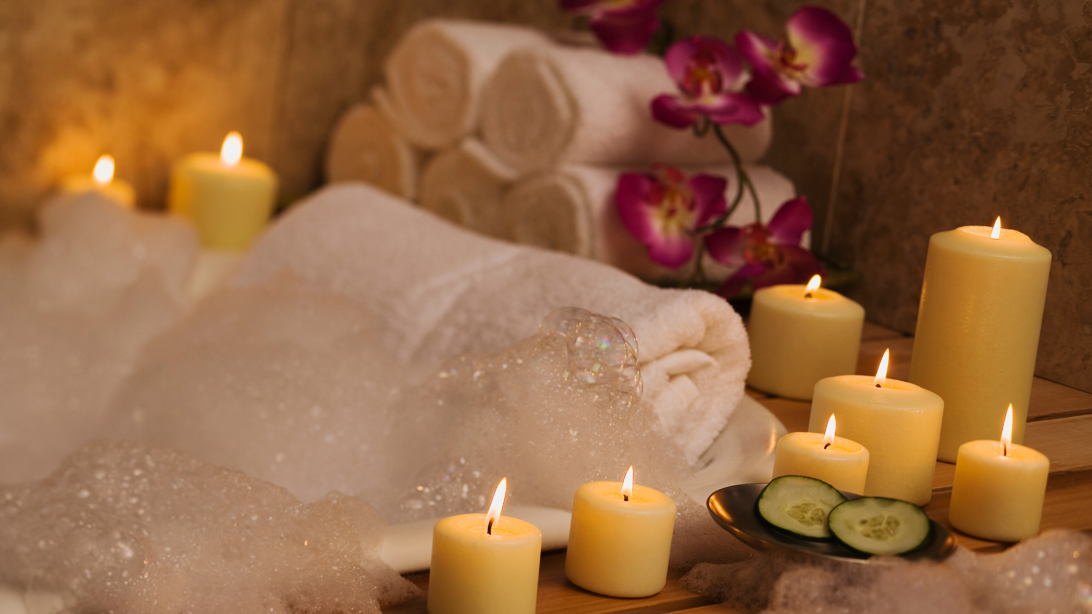 bubble bath surrounded by candles and flowers