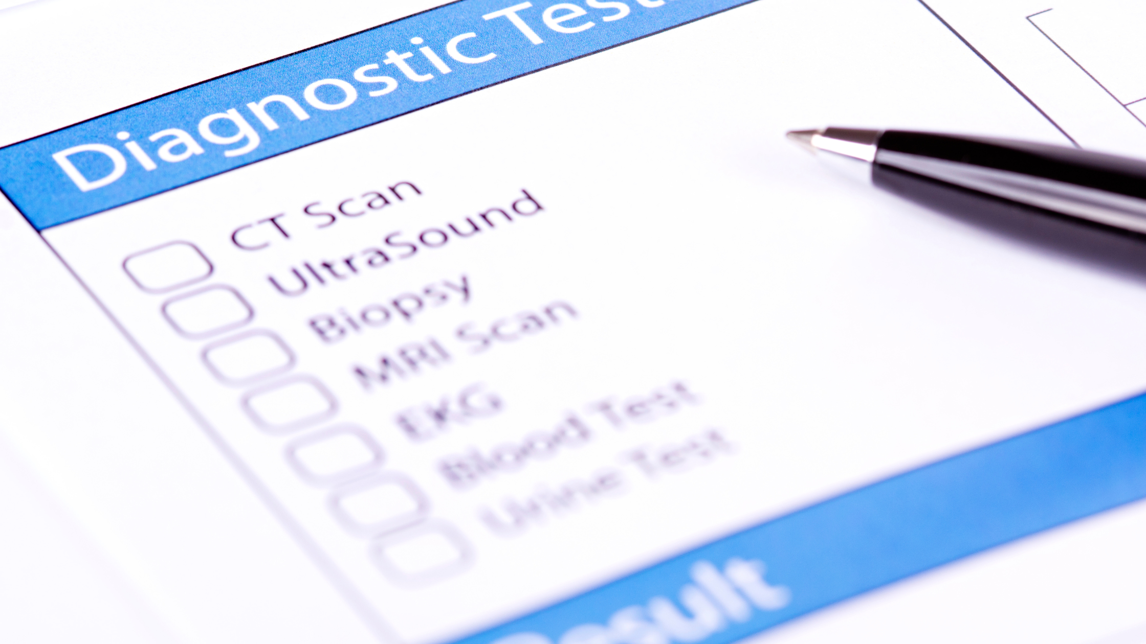 pen resting on a checklist of various diagnostic tests