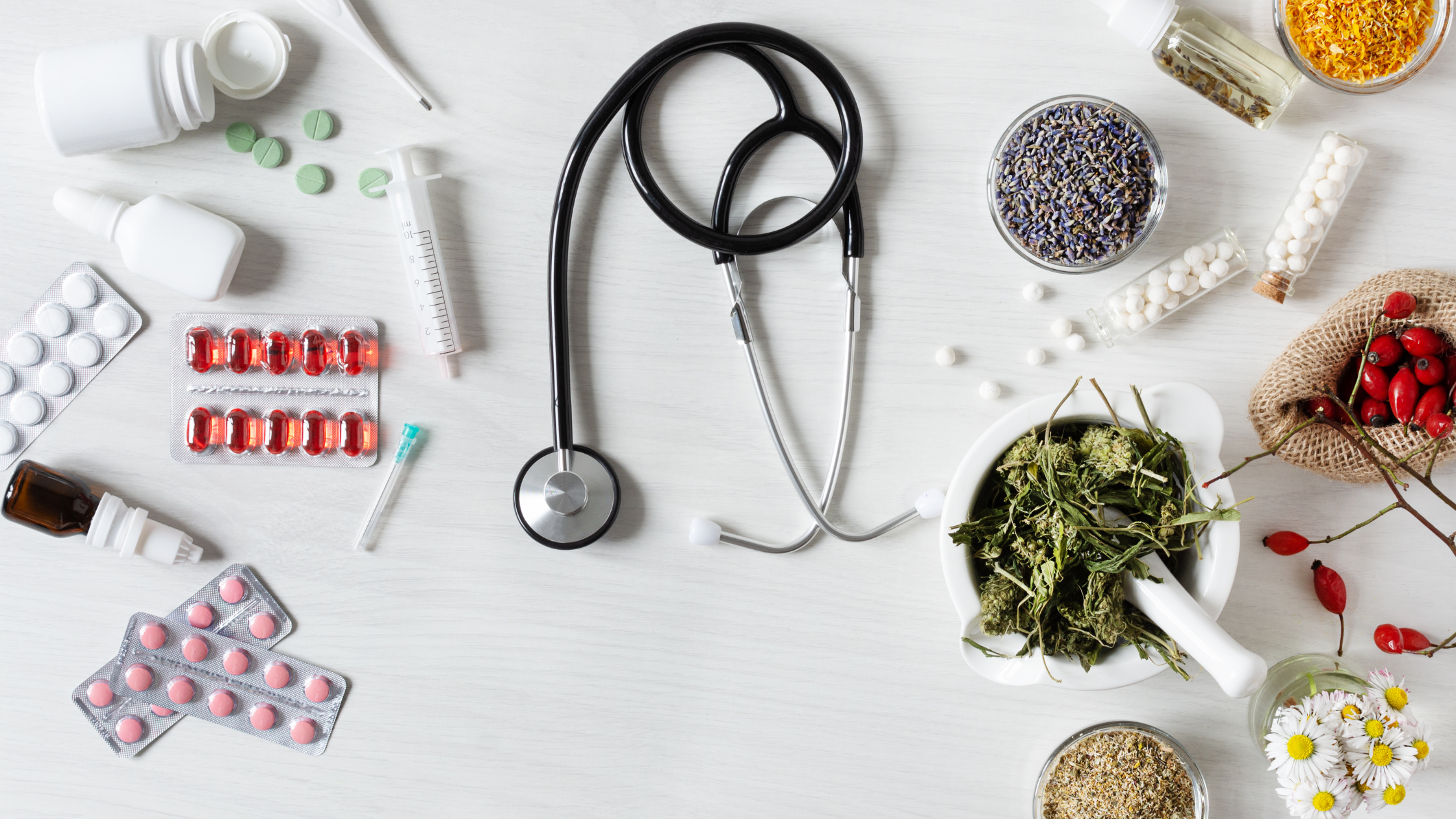 tabletop covered in medicines, herbs, and medical devices