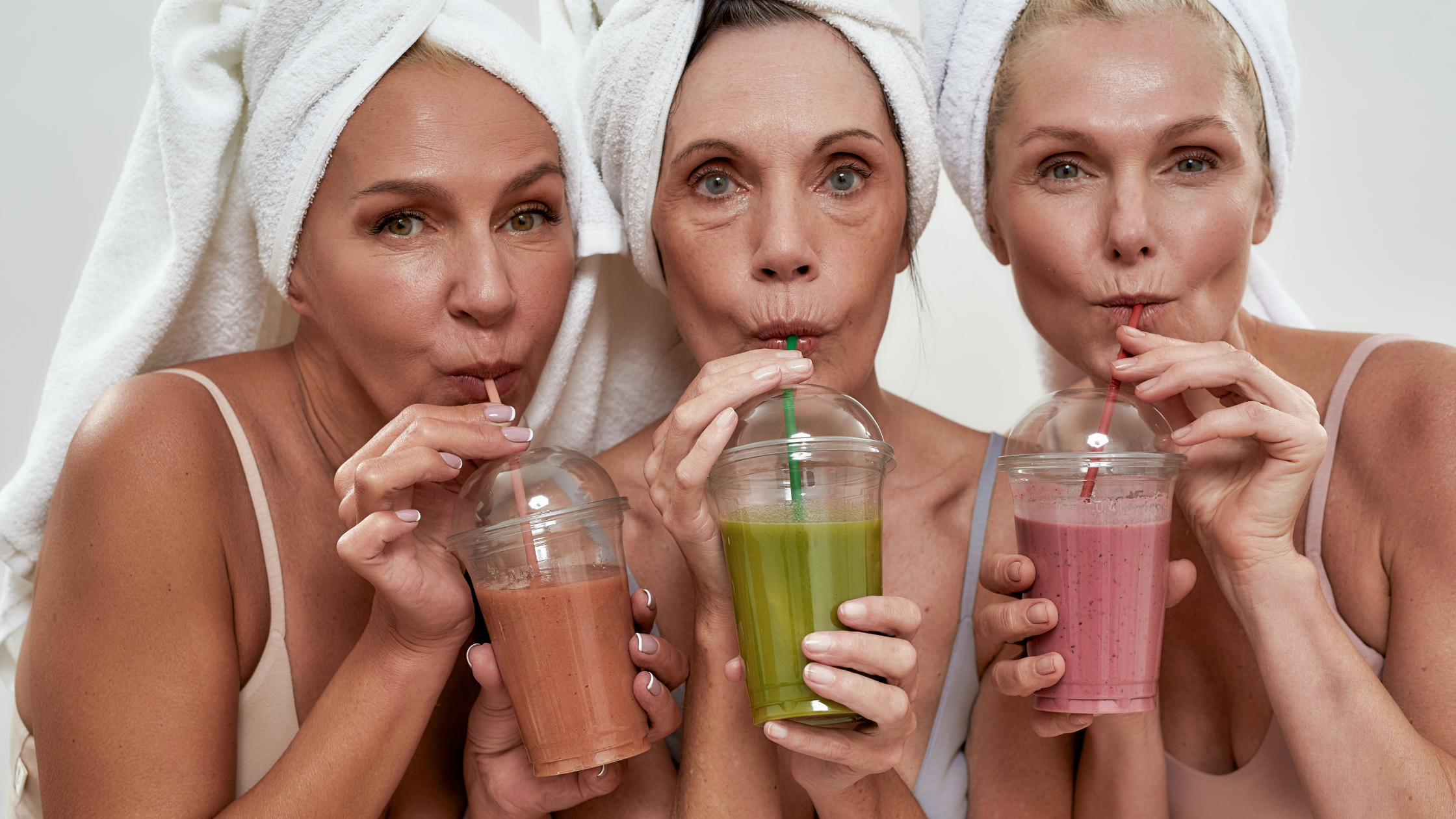 women with towels on their heads drinking smoothies