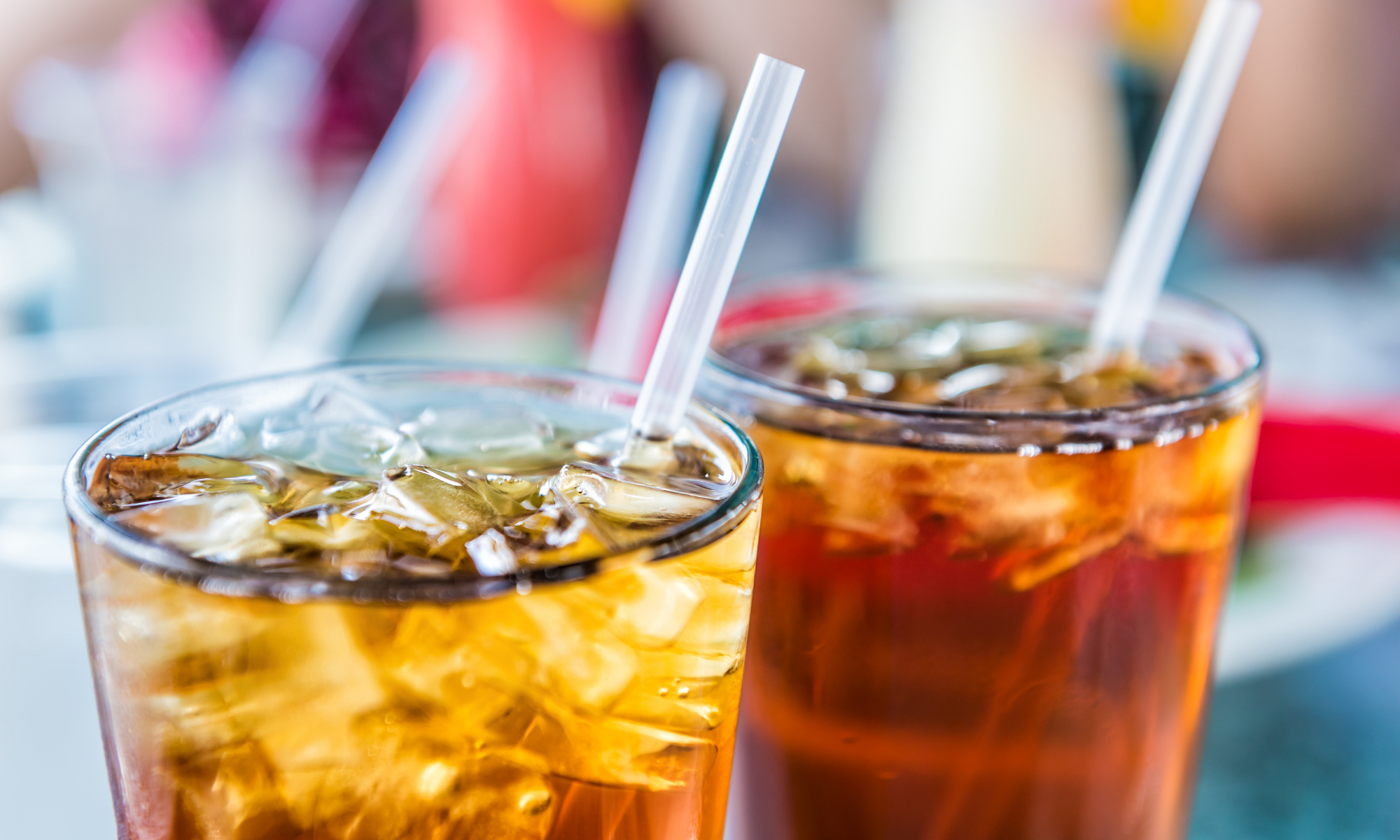 Two tall glasses of soda; Drinking sugary beverages actually increases thirst and packs in calories without nutritional benefit