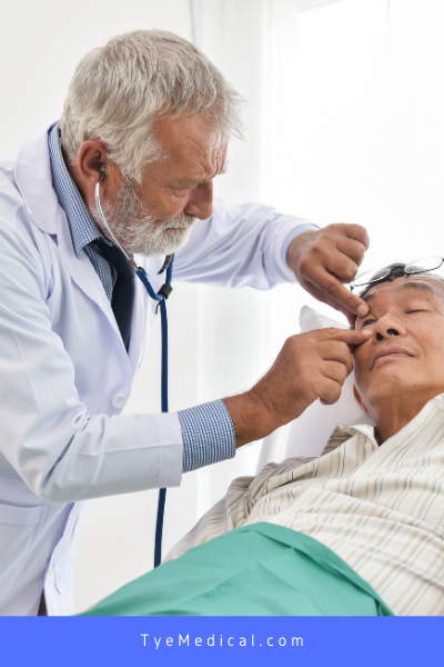 An eye doctor performs an examination on an older patient