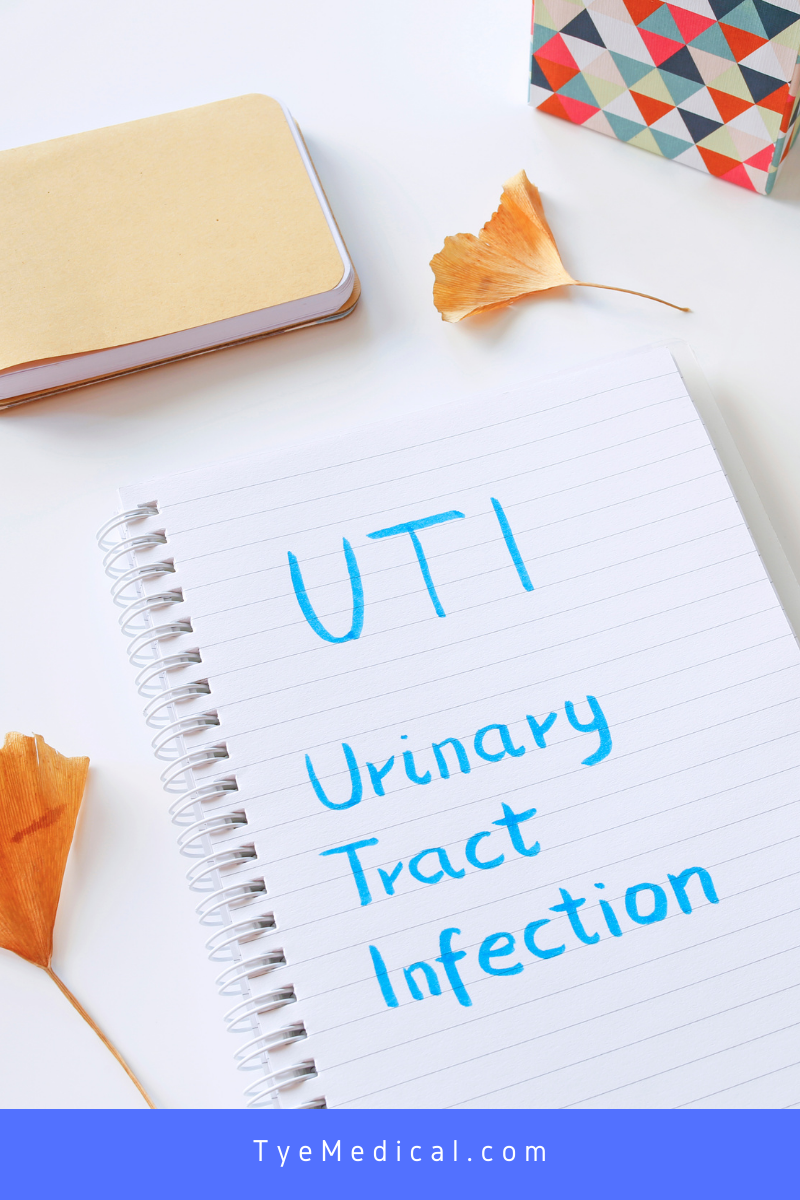 Spiralbound notepad with the words "UTI Urinary Tract Infection" written on it