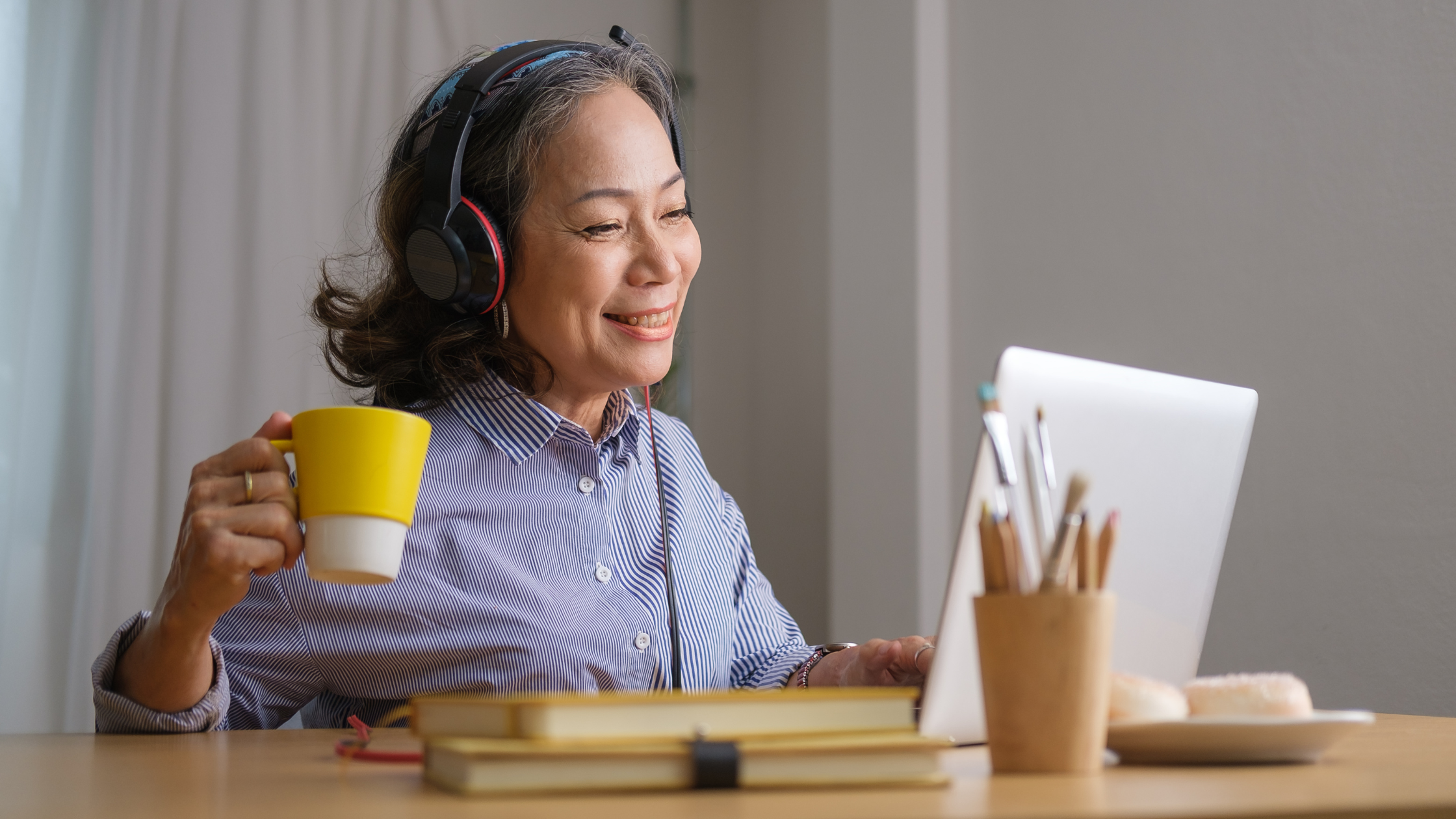 smiling senior woman in front of a laptop