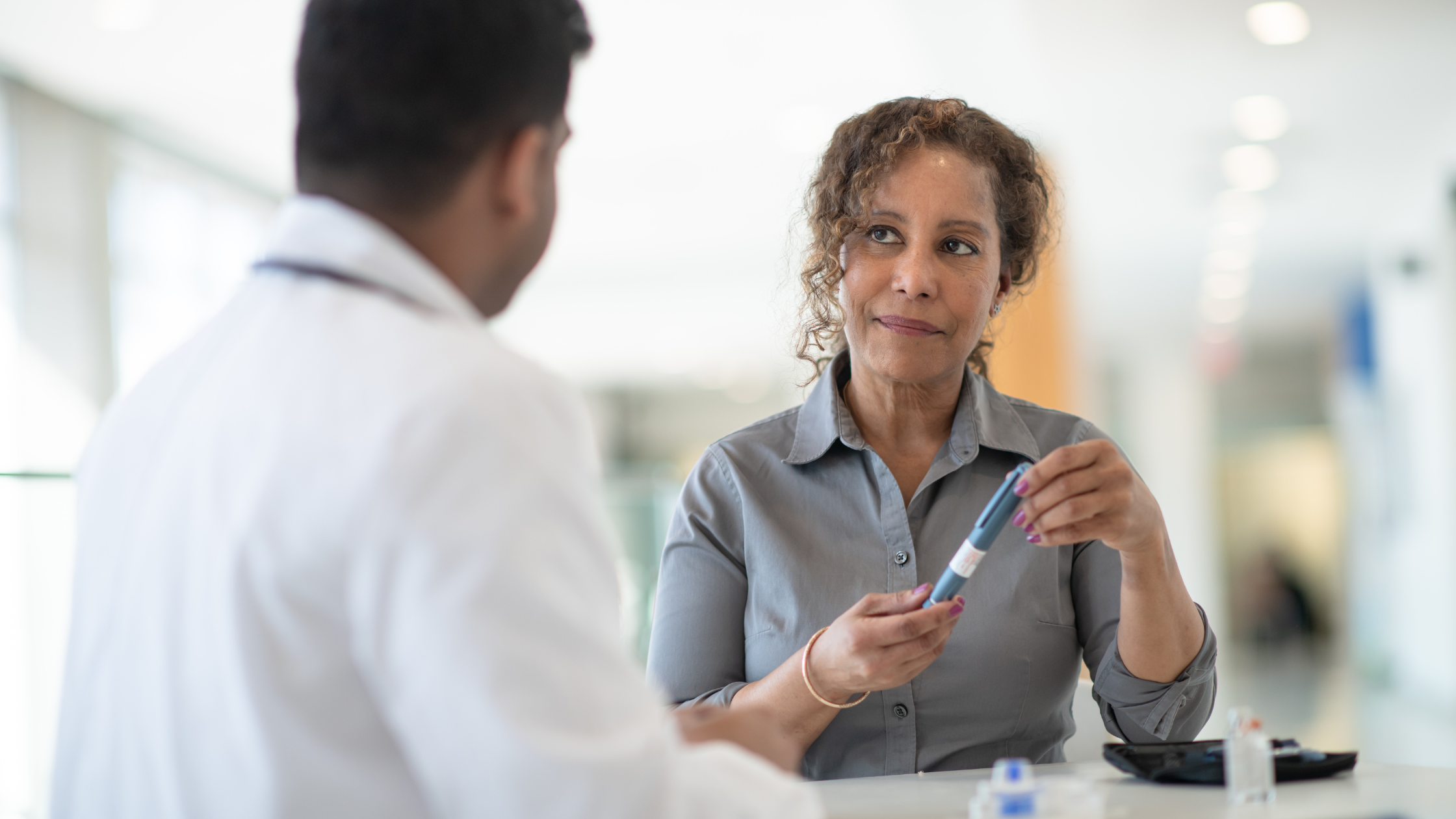 male doctor talks to a senior woman