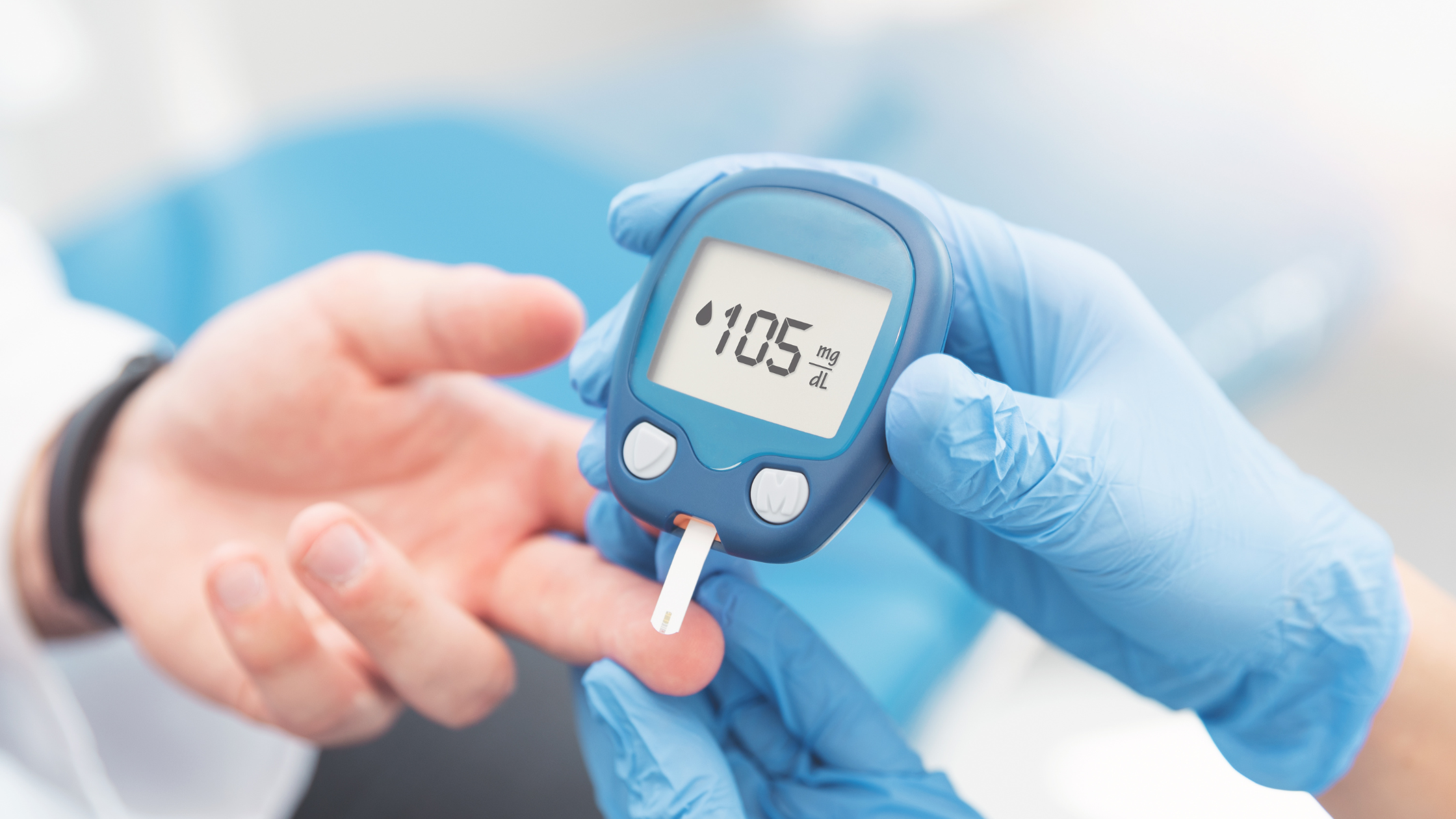 Person checks their blood sugar using a finger-prick device