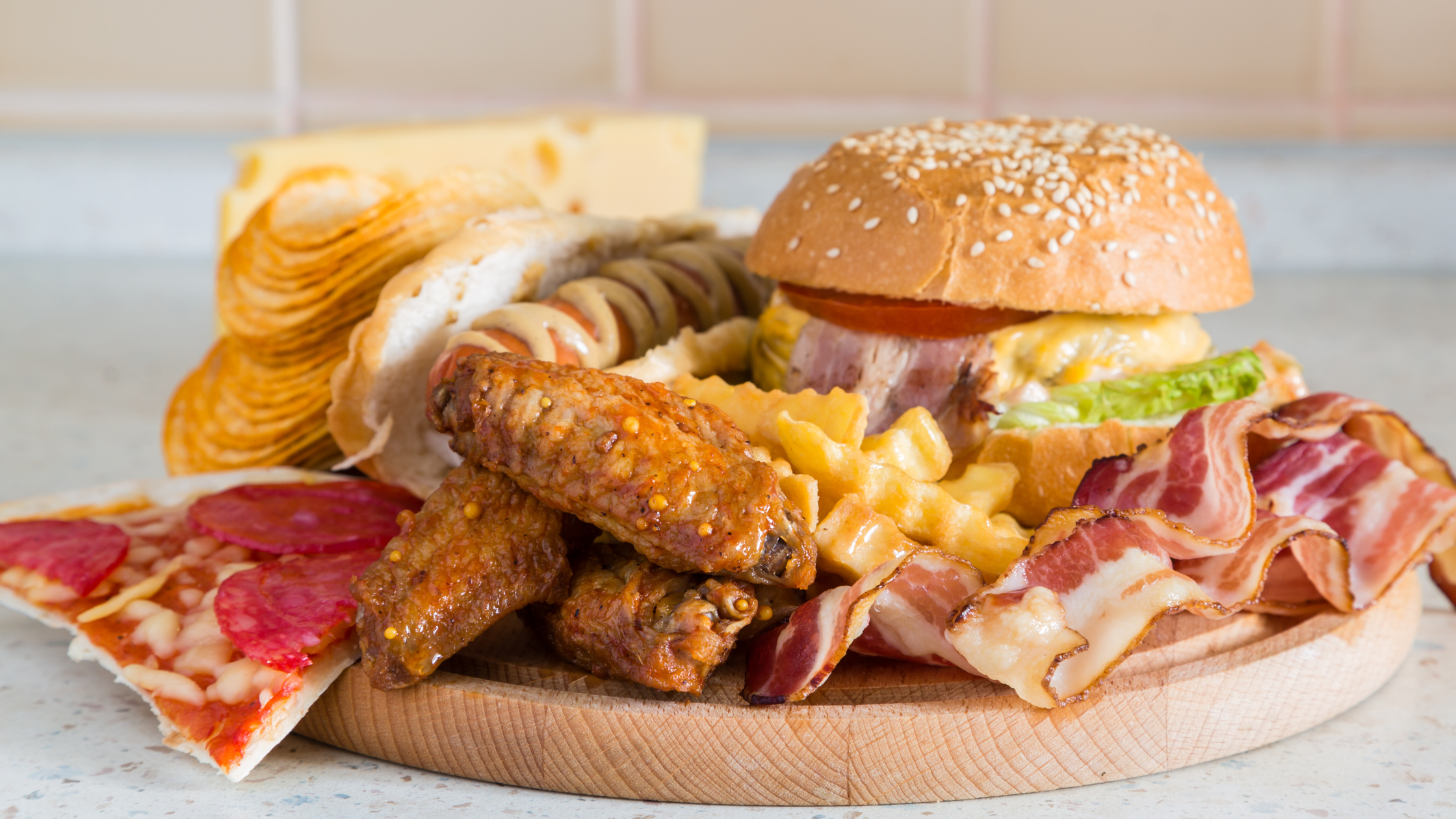 plate overflowing with fries, bacon, pizza and more