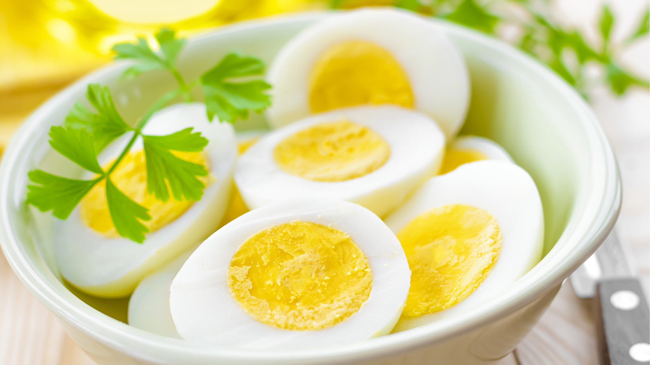 white bowl filled with slices hard-boiled eggs