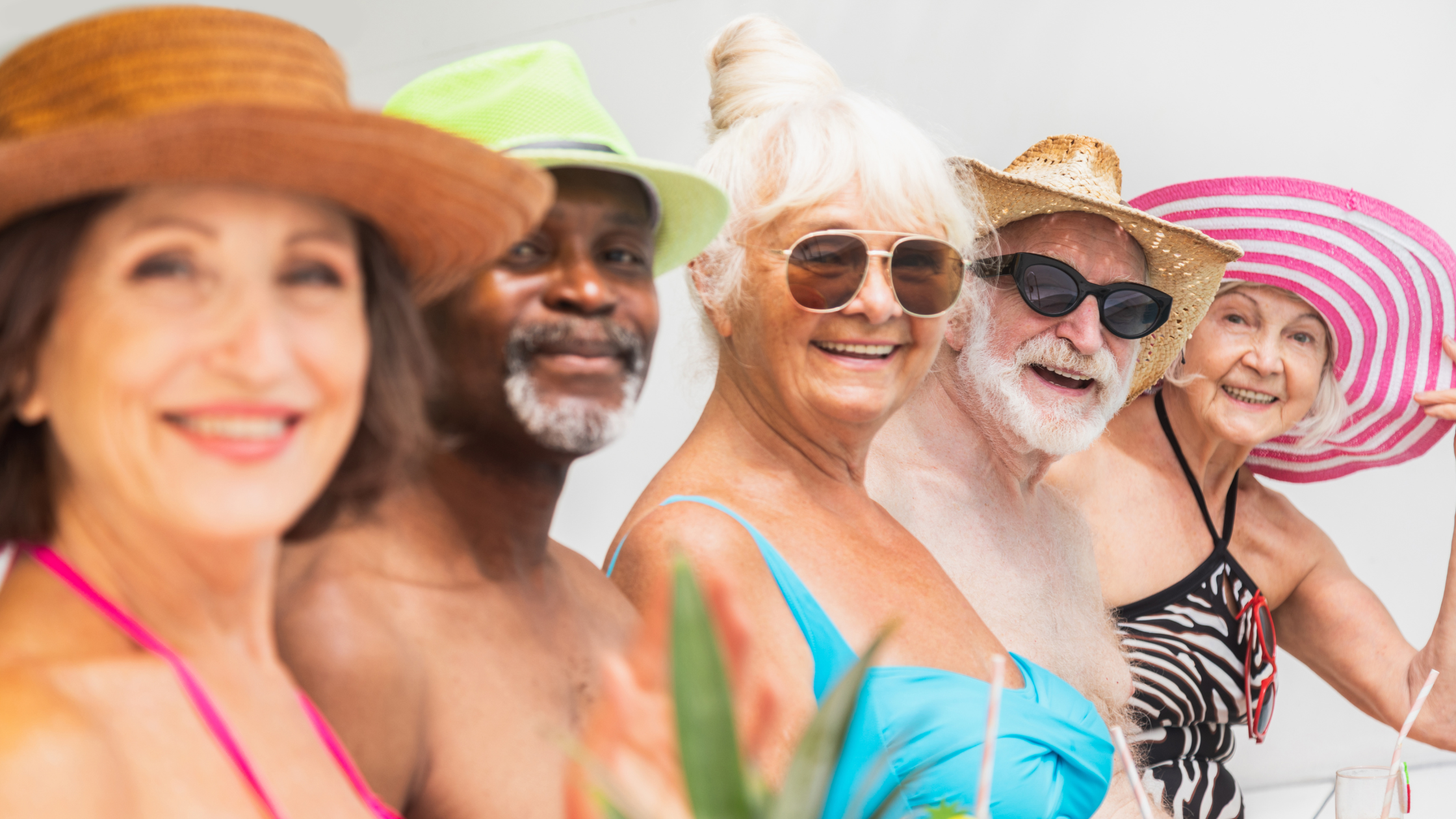 group of smiling seniors in swimwear