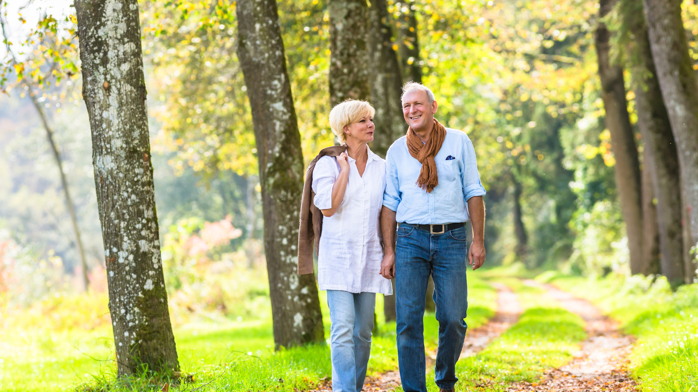 senior couple strolling through the woods