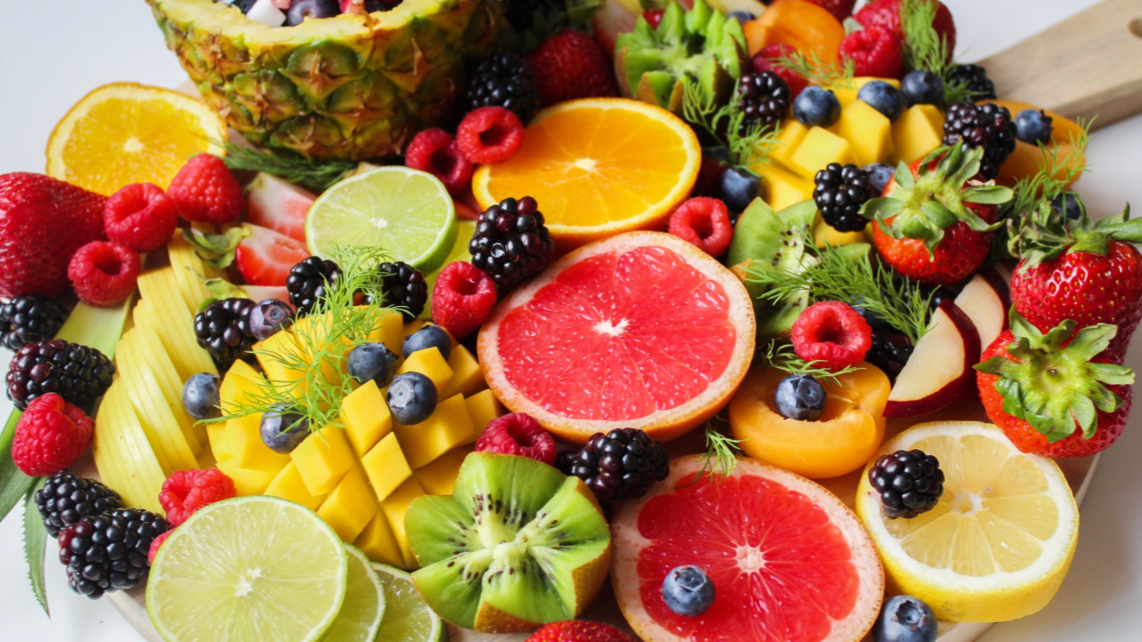 large pile of berries and sliced fruit