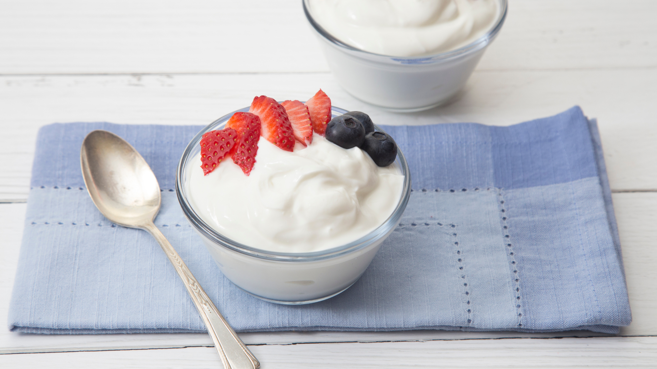 bowl of plain greek yogurt with fresh berries on top