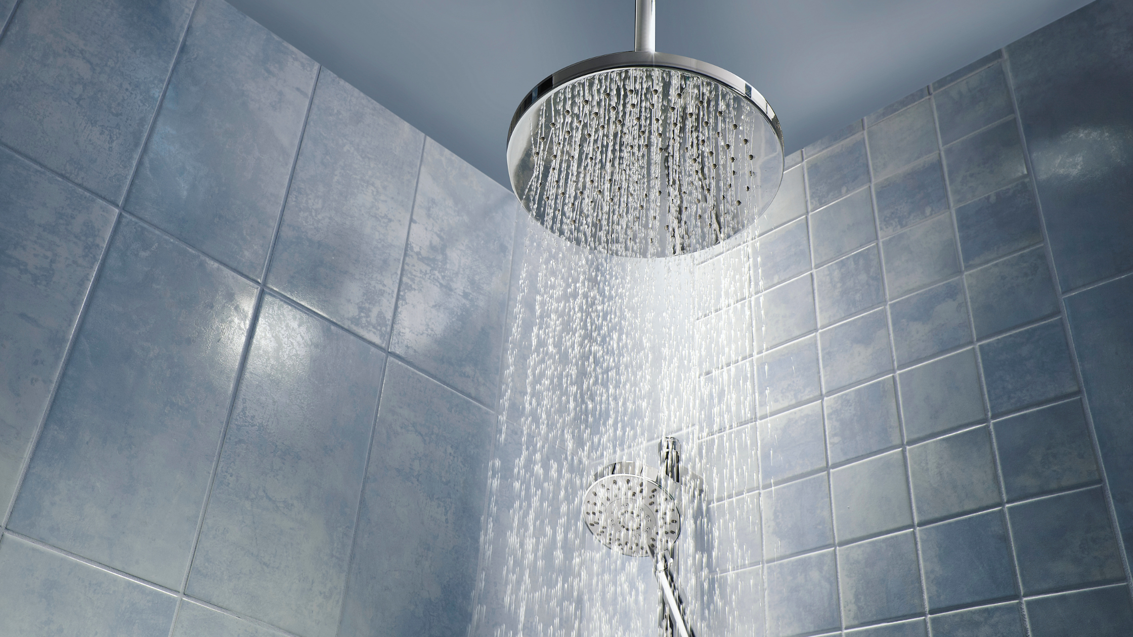 steamy water drips down from a showerhead