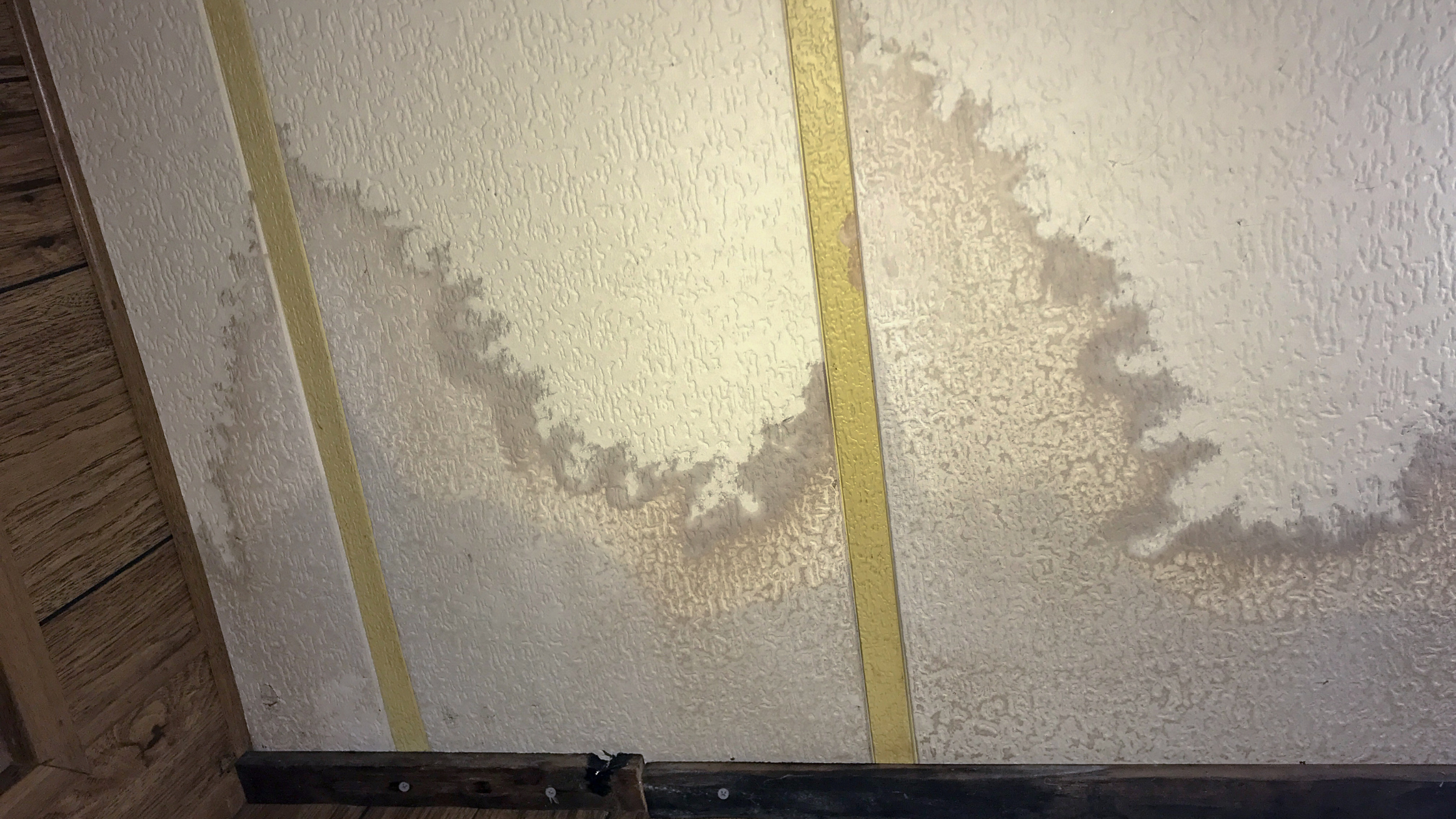 ceiling panels stained and splotchy from a leak above