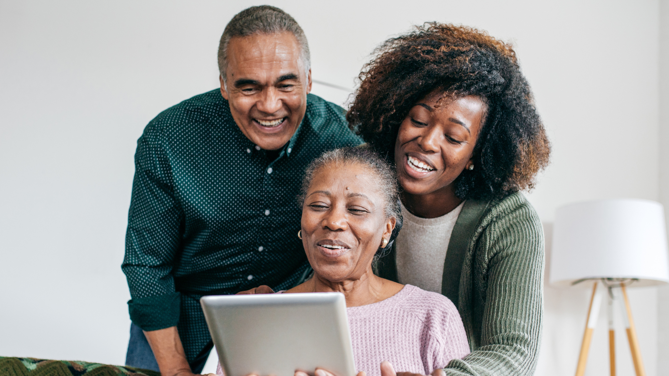 family of three gathered around a tablet