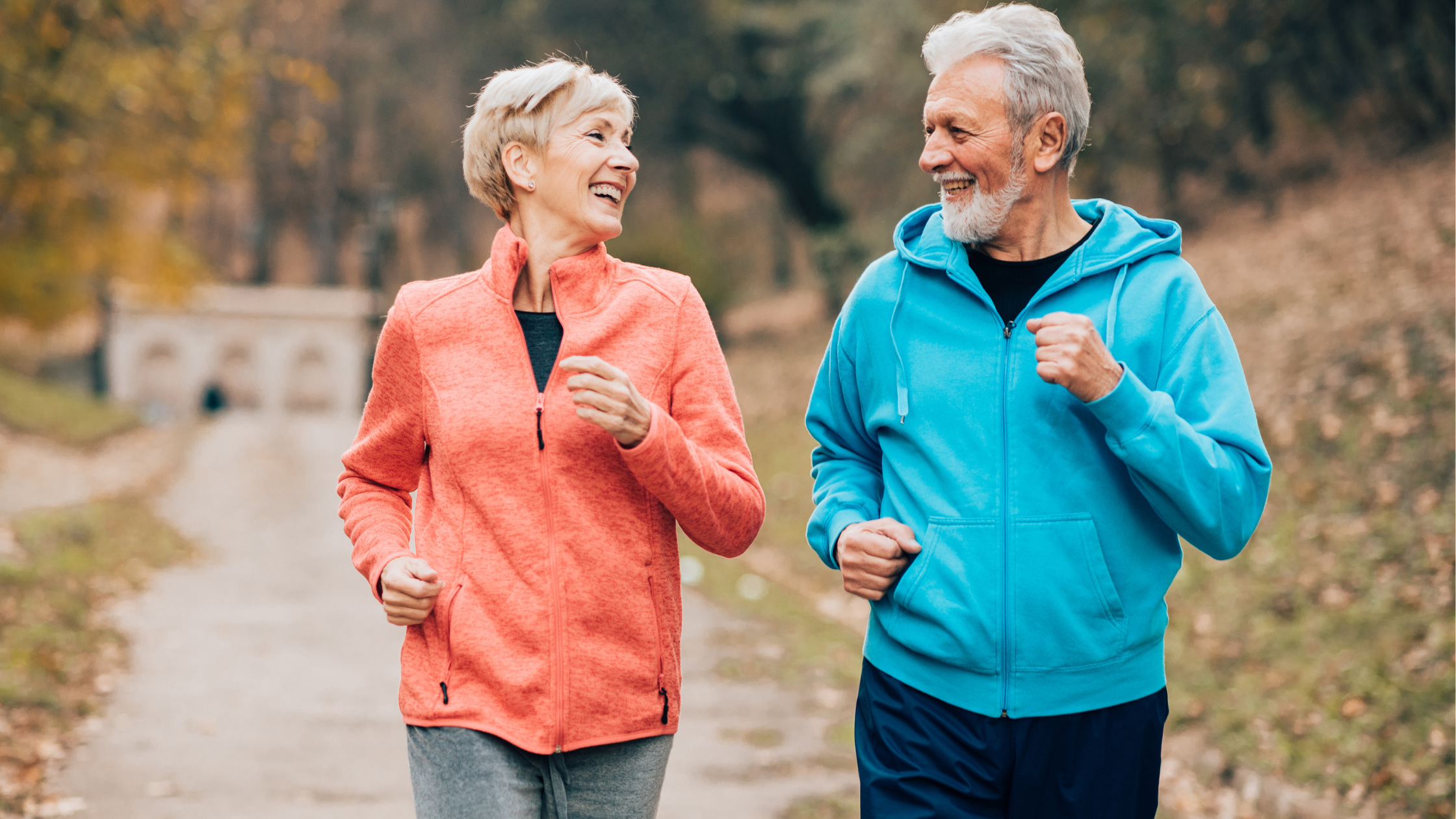 two running seniors smile at each other