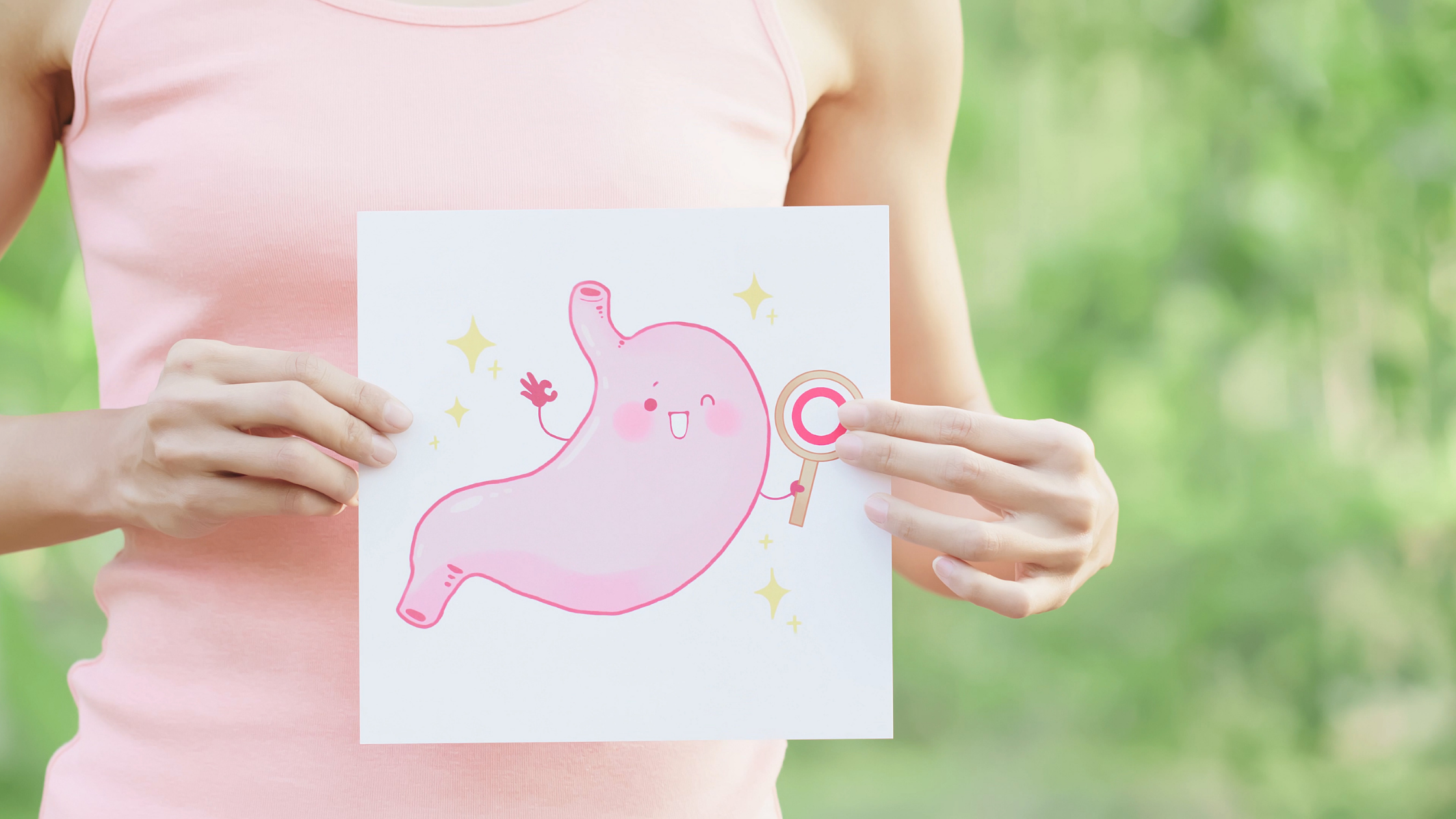 Woman holding illustration of a bladder with a smiley face on it