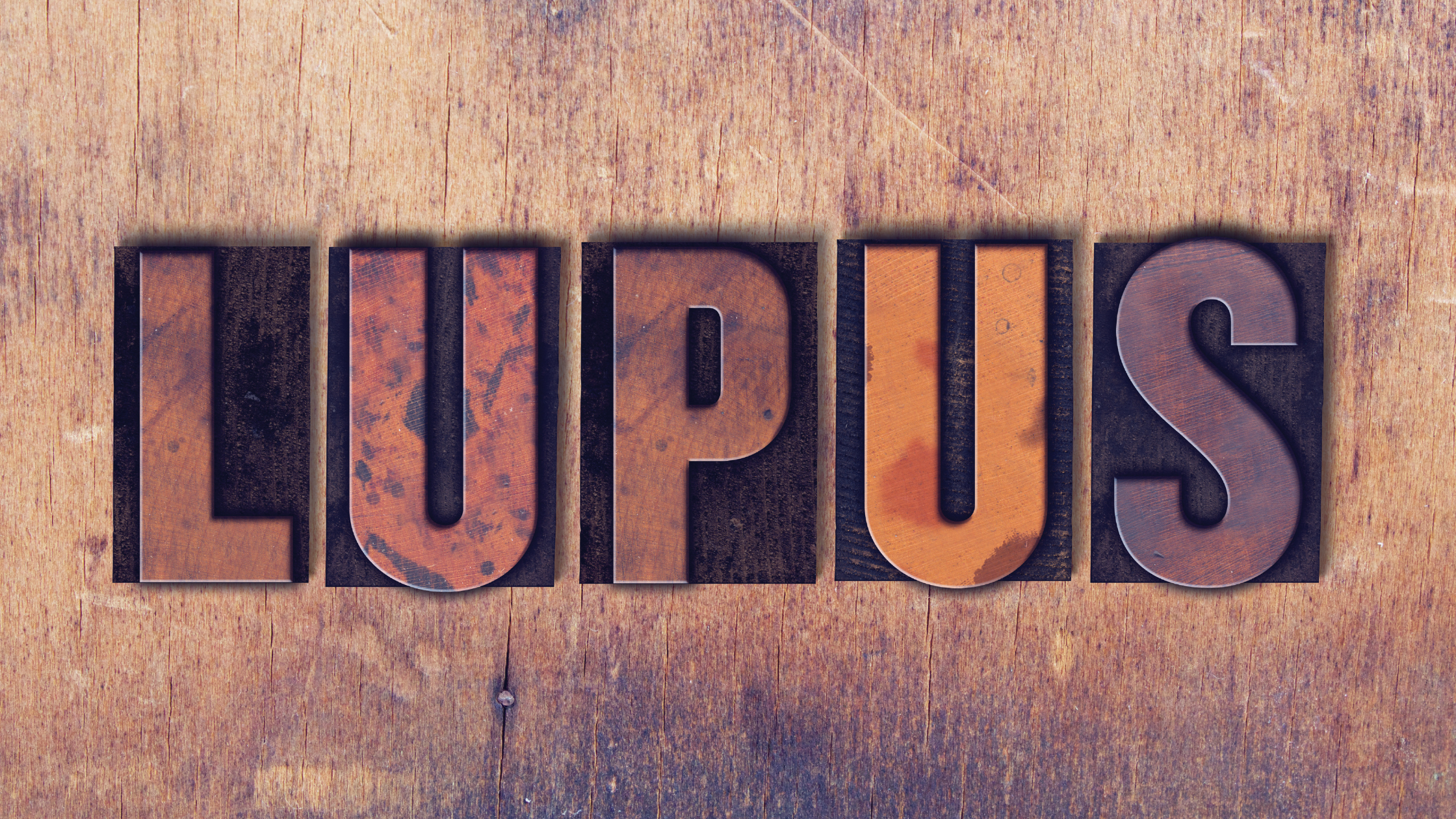 Wooden block letters spell out "Lupus"