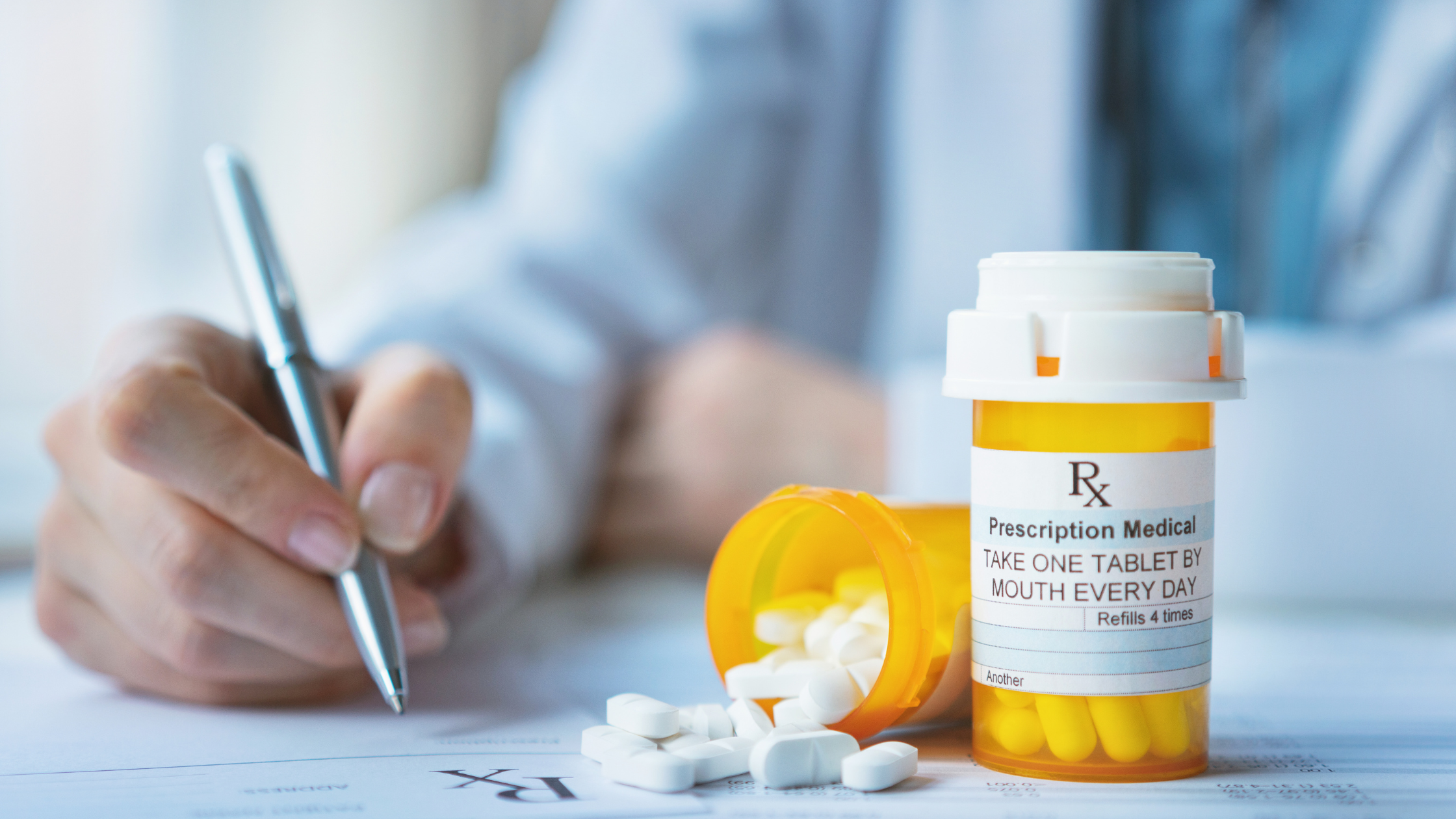 doctor writing on a pad next to bottles labeled "prescription"