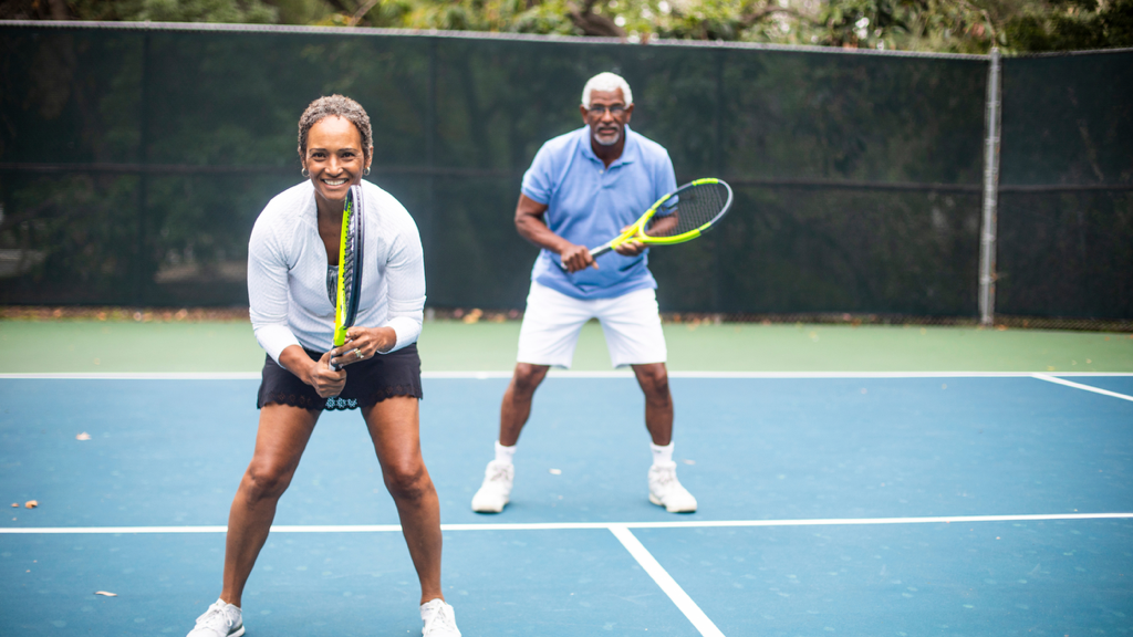 seniors play tennis in pairs