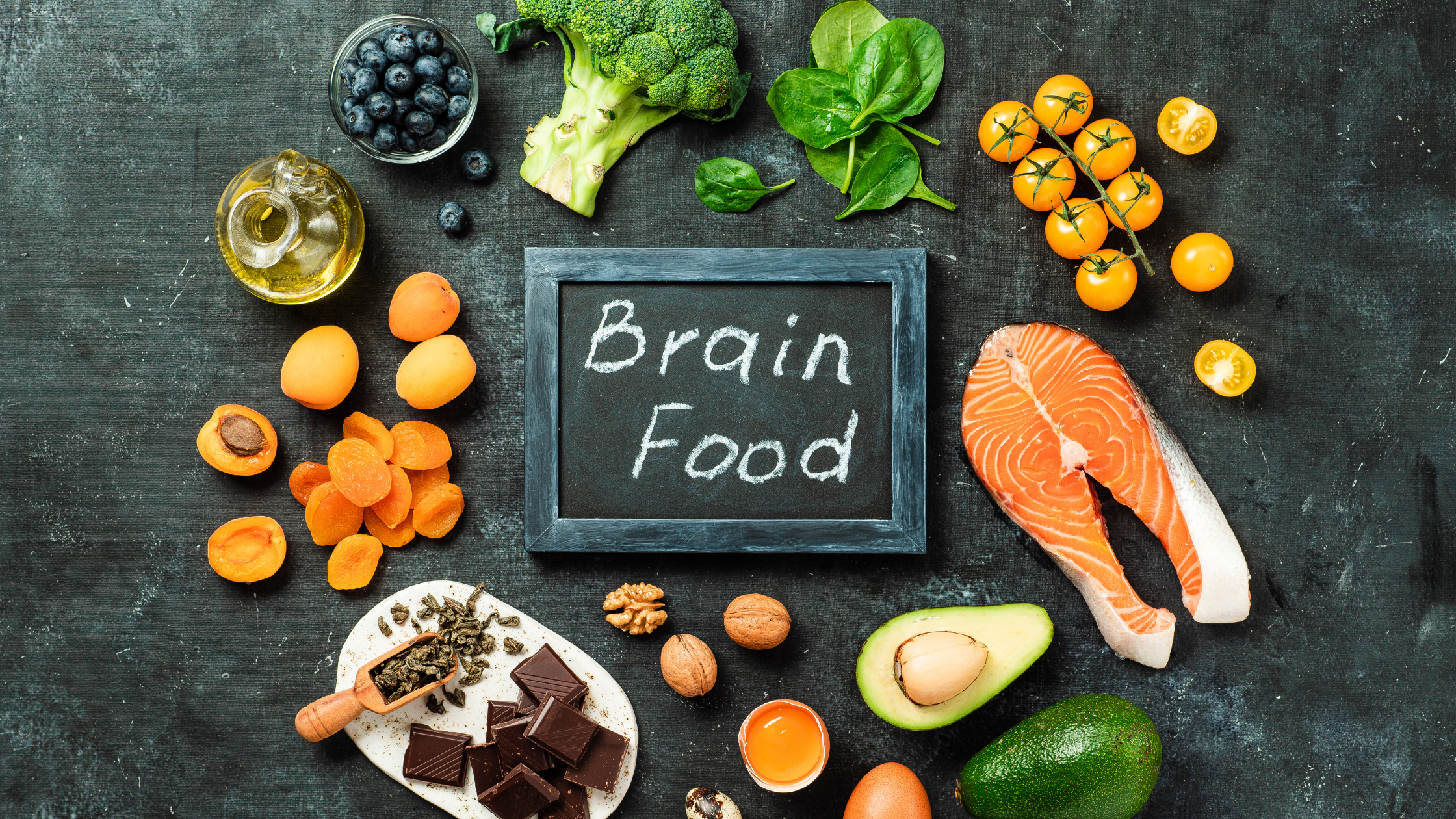 blackboard saying "brain food" surrounded by produce and fish