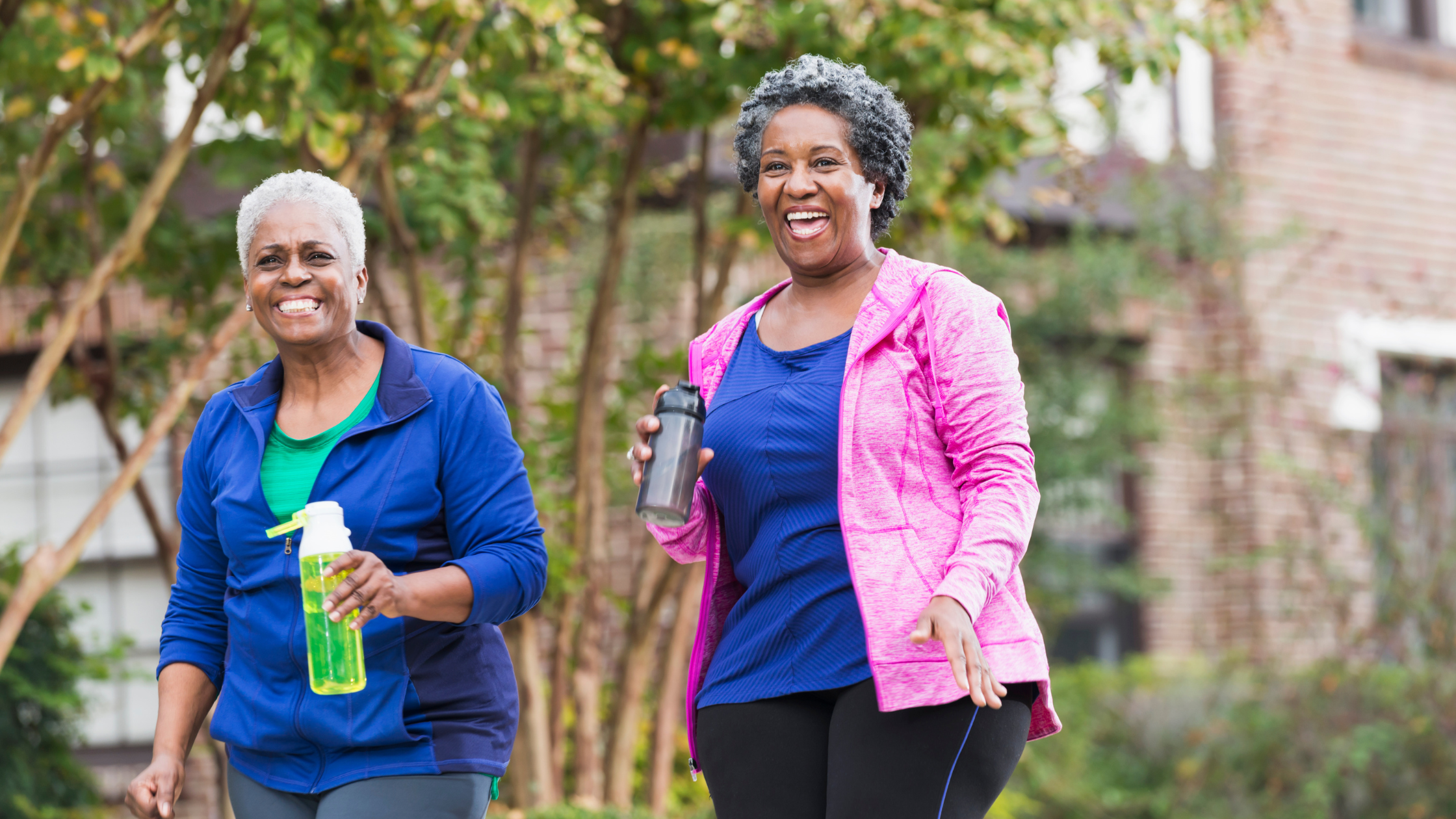 happy women walk outside together