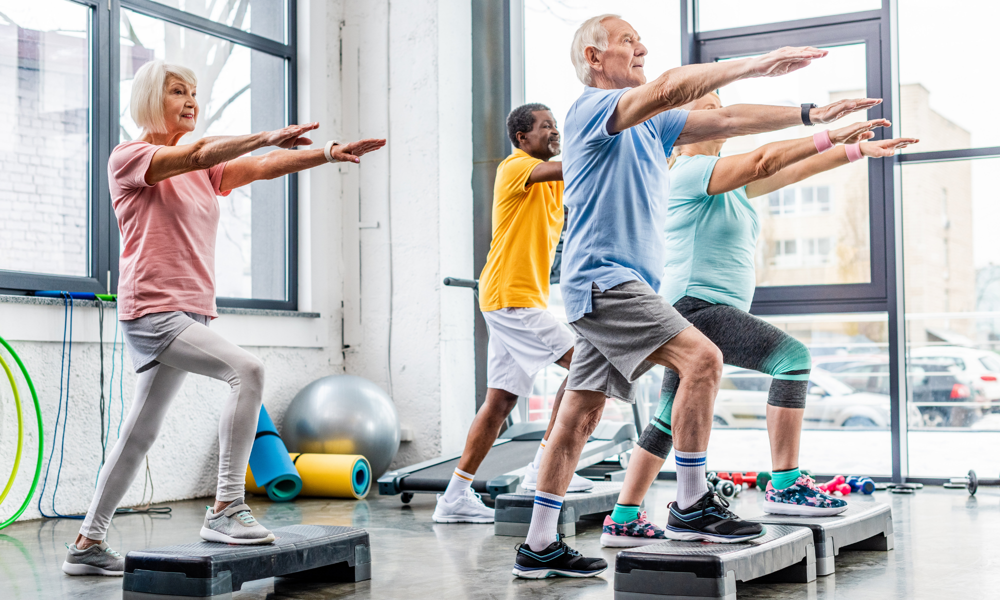 Seniors doing group exercise in a studio