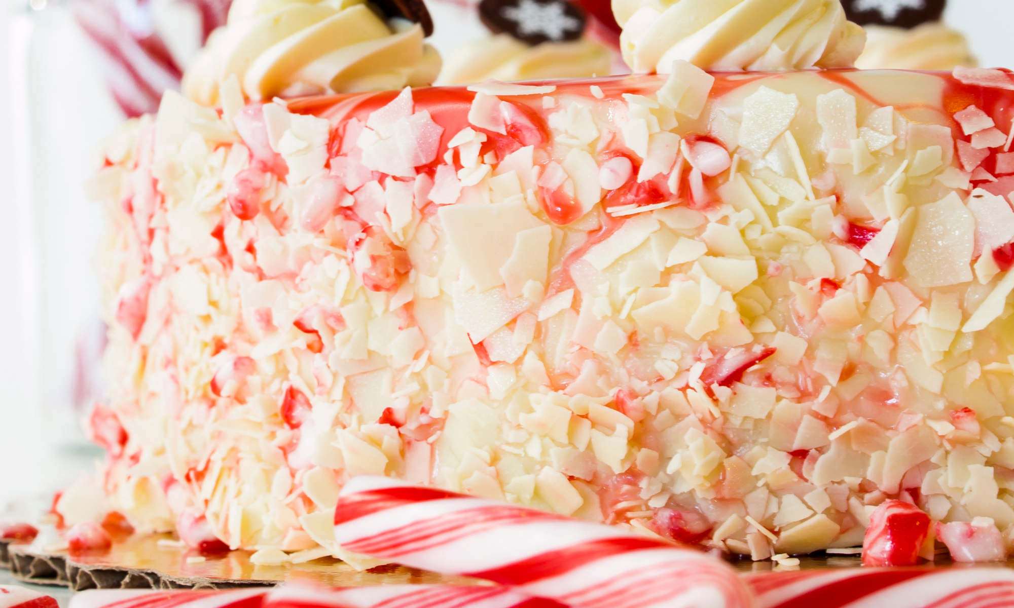 Fresh peppermint cheesecake pie covered in flaky bits and whipped cream