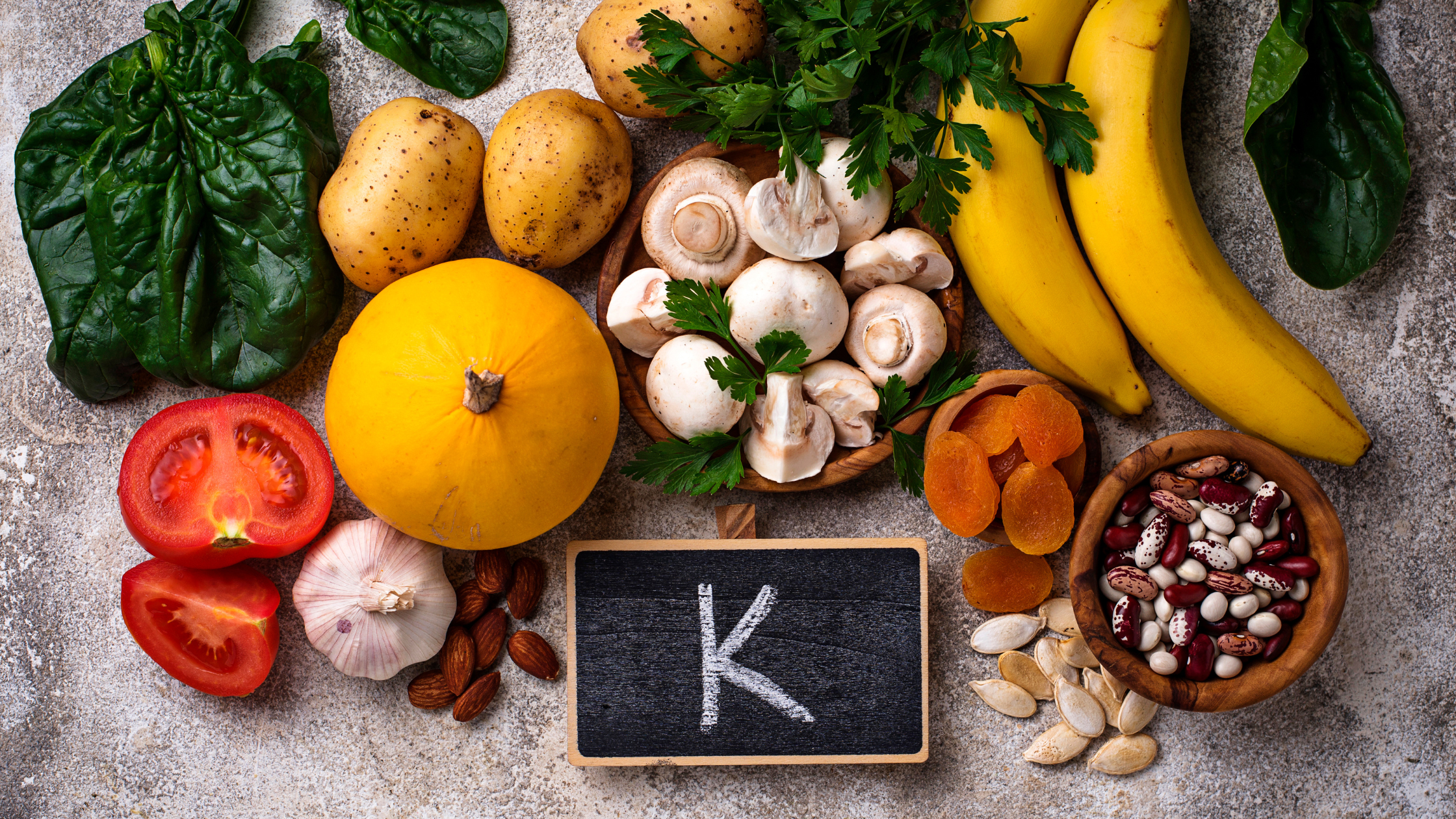 table of high potassium foods like spinach and bananas and nuts