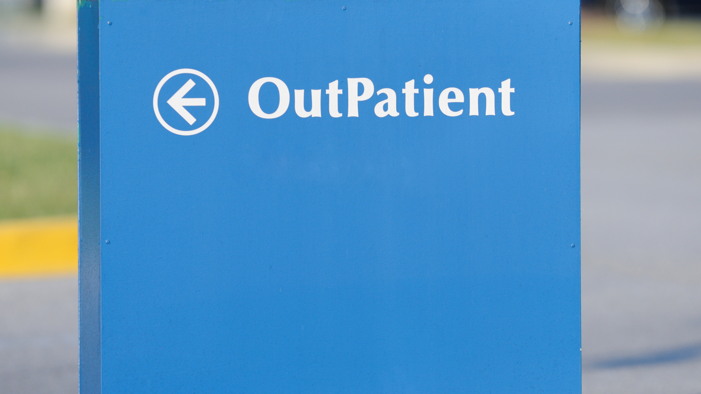 blue sign with an arrow reading "outpatient"