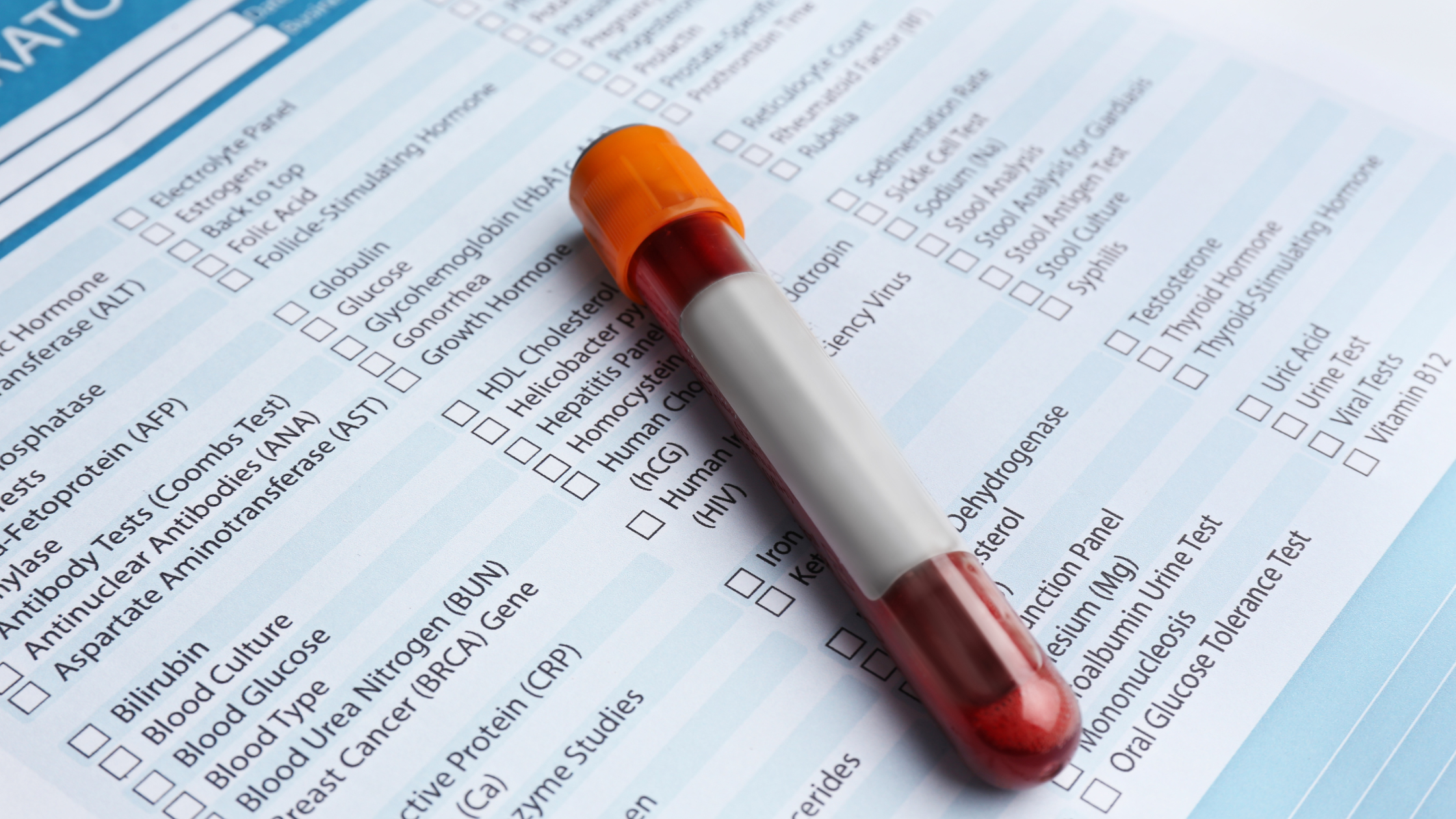 blood vial sitting on a check list of potential conditions to test for
