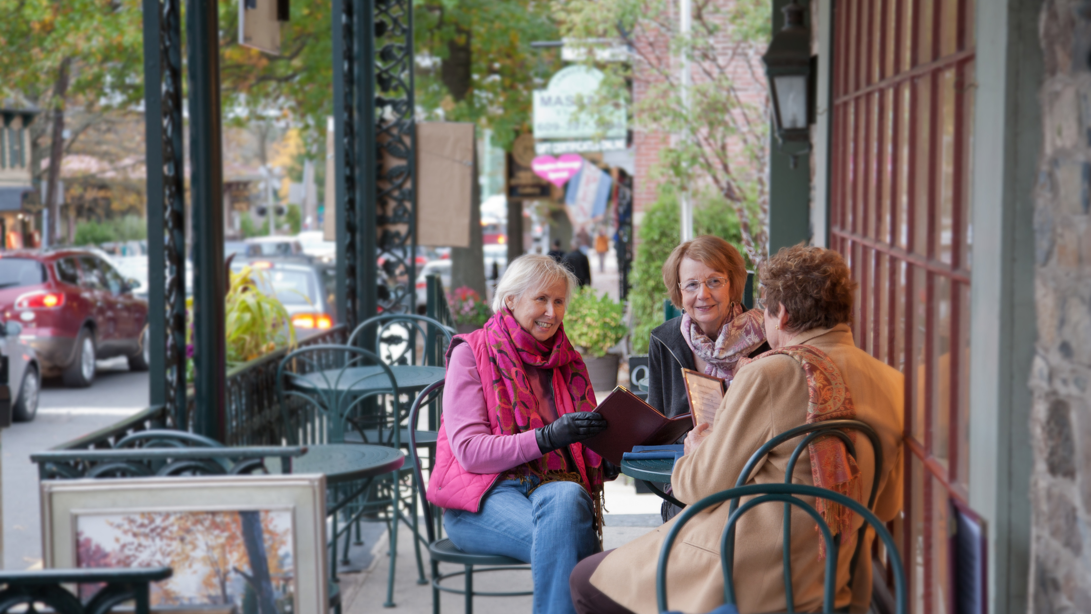 seniors sit and chat at a cafe