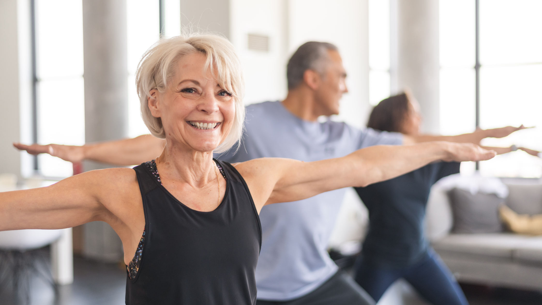 smiling seniors at a yoga class