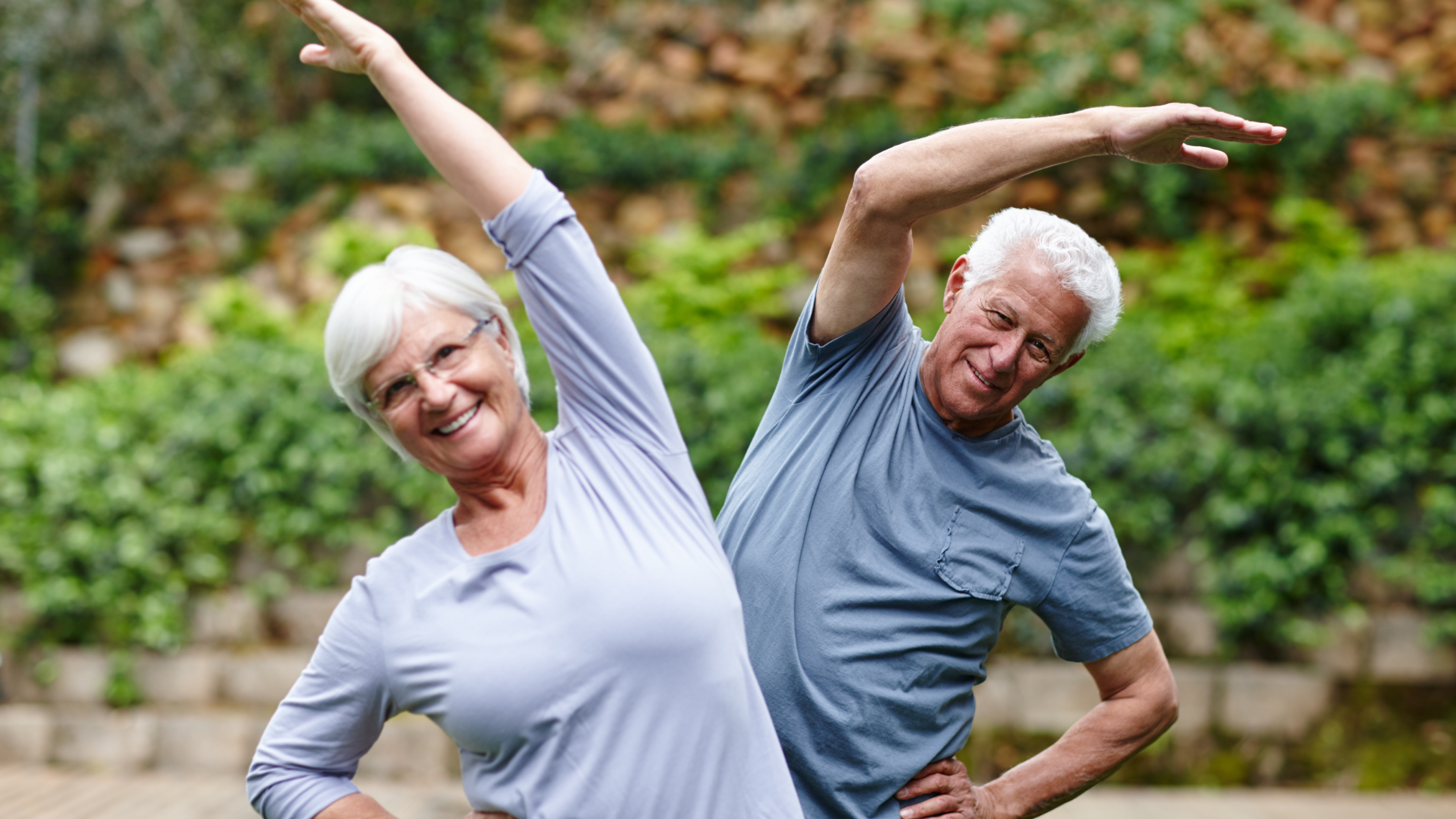 smiling seniors stretch together
