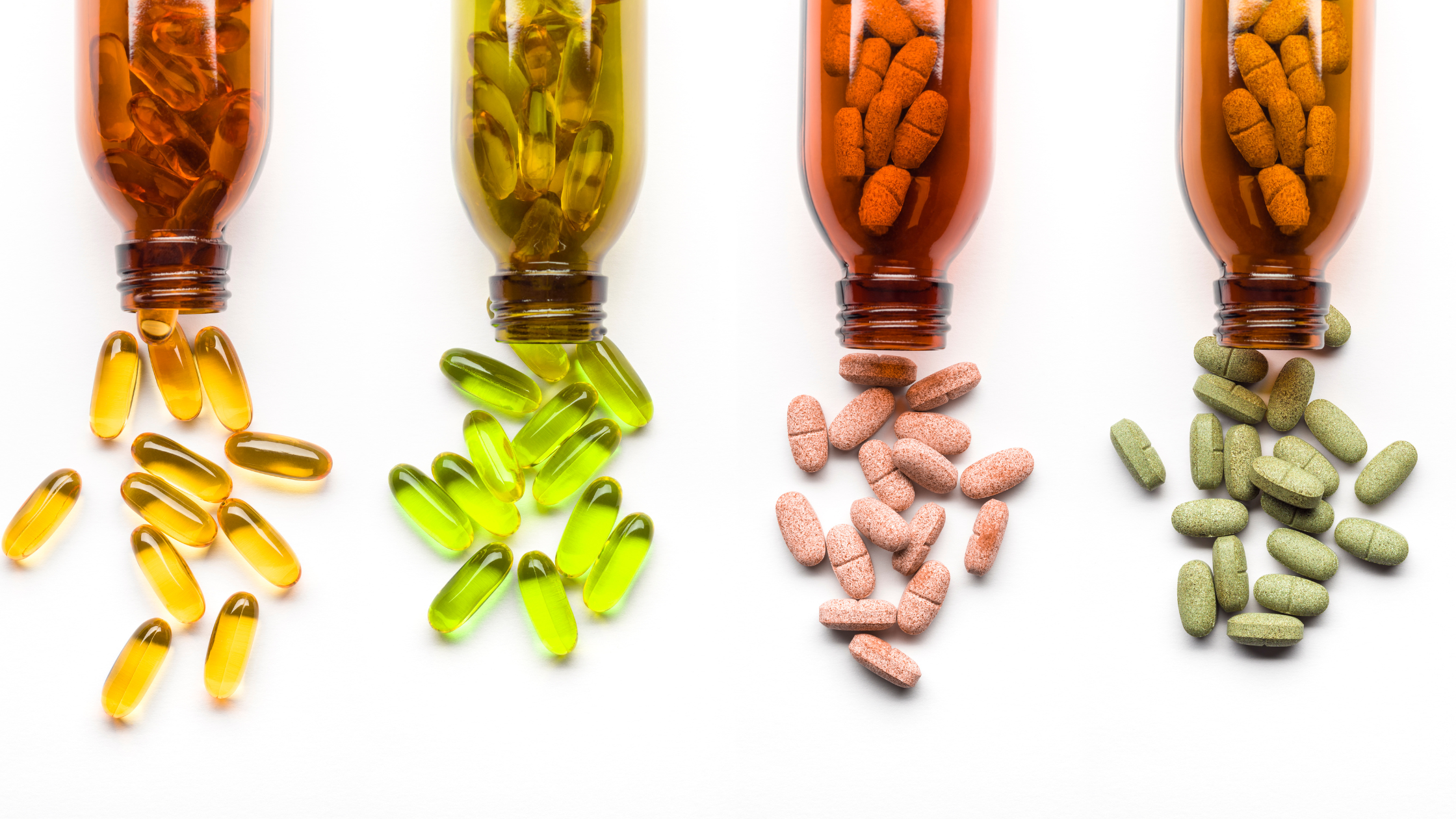 four bottles spilling out colorful supplements