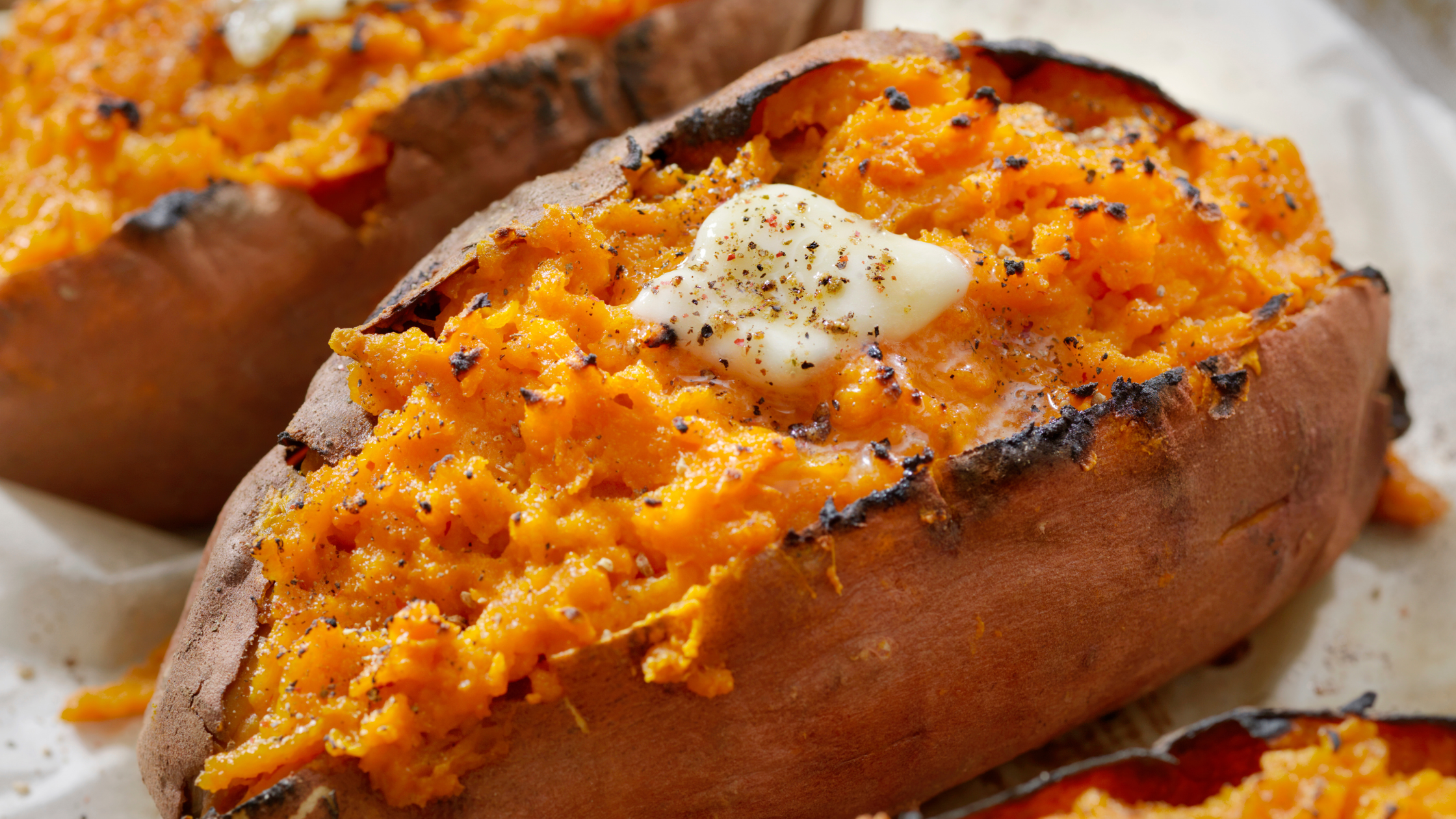 baked sweet potatoes with butter and seasonings on top