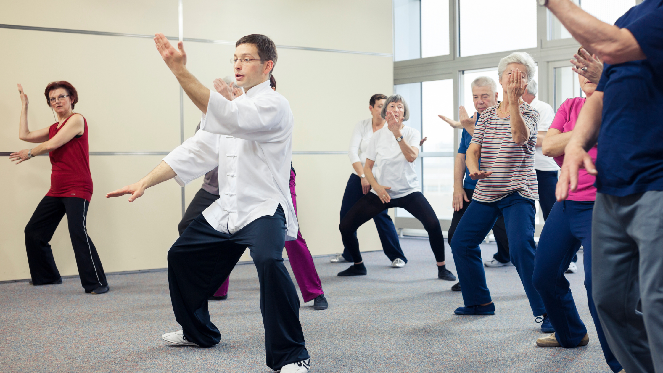 senior tai chi class in a well-lit room