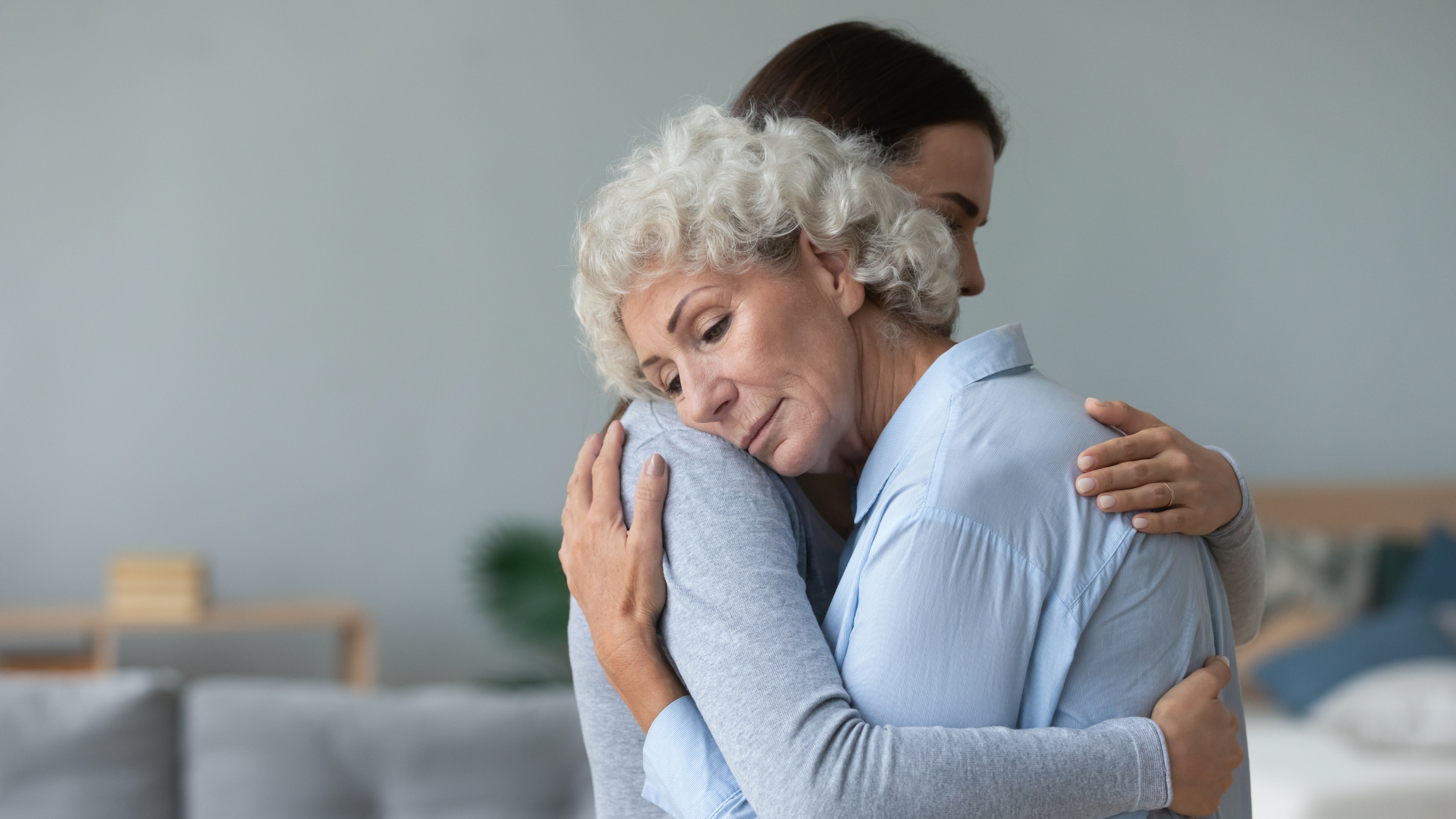 sad-looking people in a soft embrace