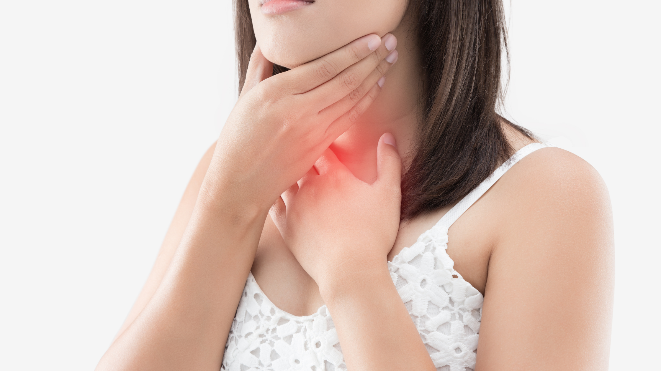 A woman holds both hands over her sore throat
