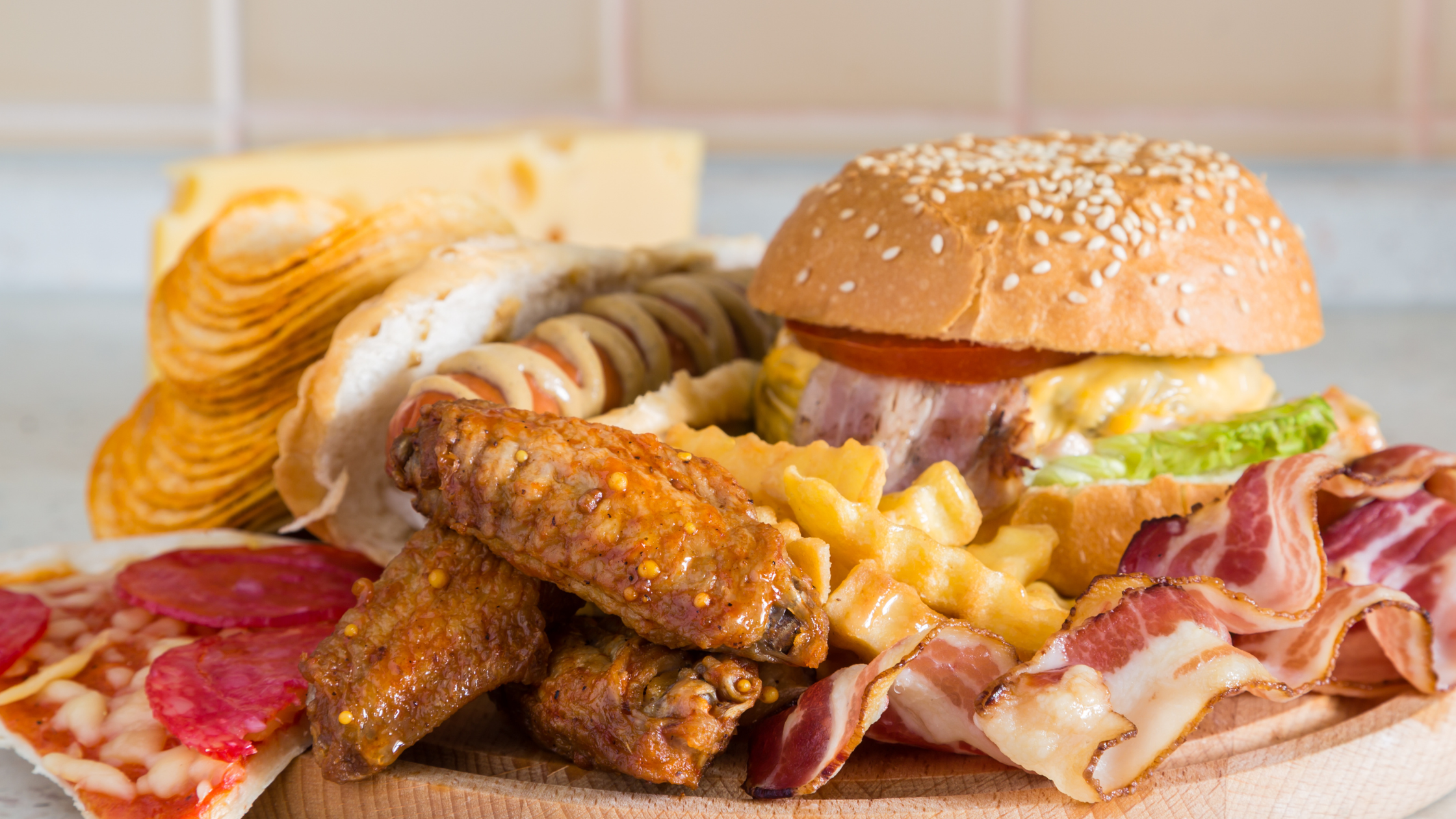 big plate of a hamburger, pizza, and fried food