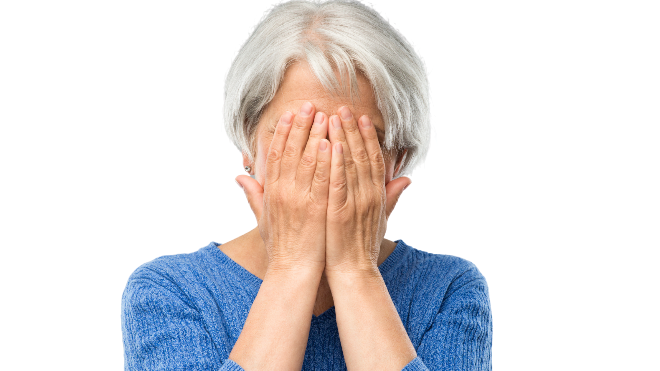 senior woman holds her head in her hands