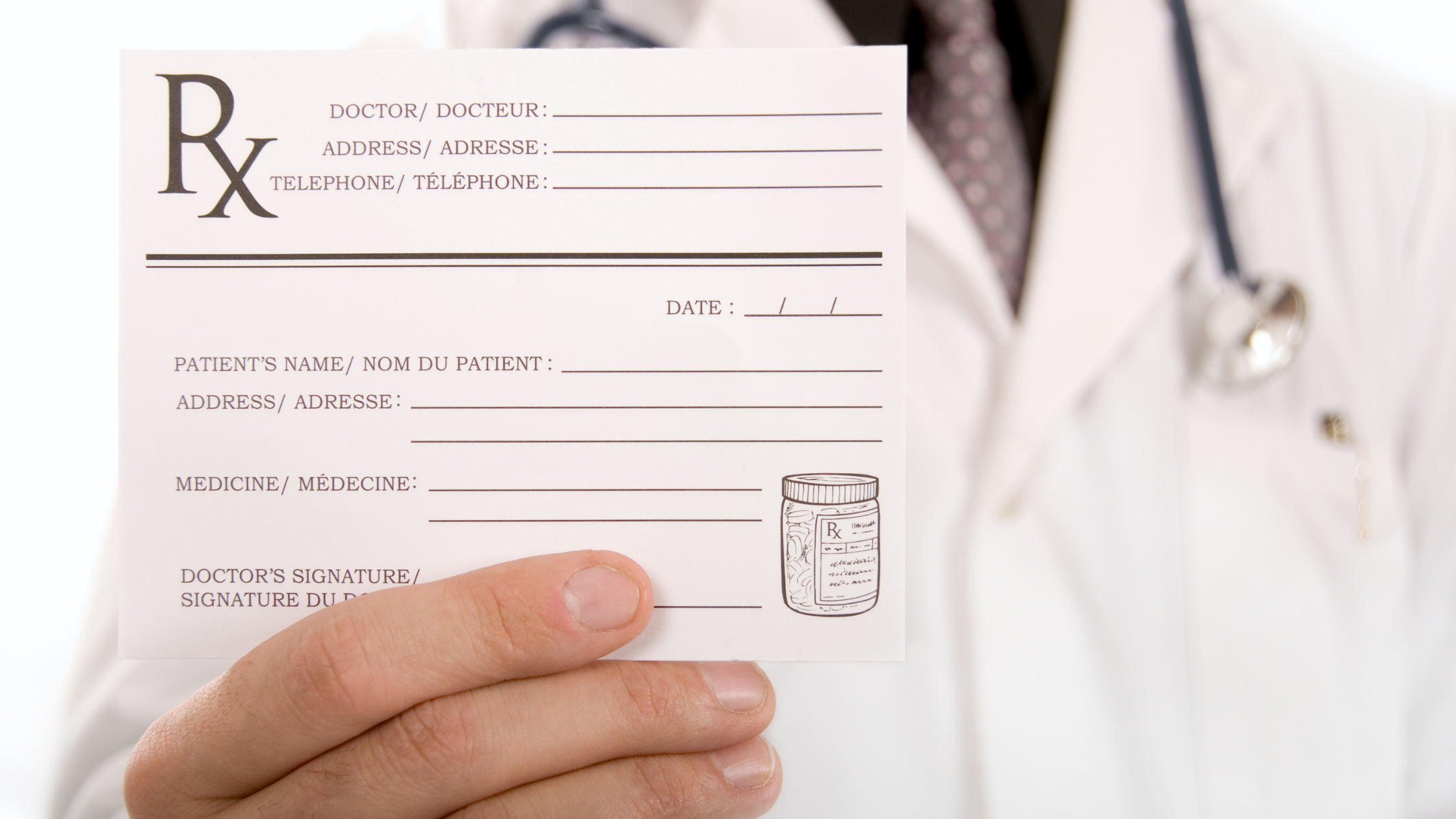 doctor holding up a blank prescription sheet